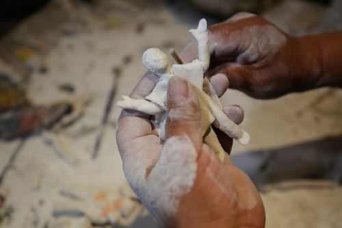 Los artesanos modelan a mano la masa preparada sobre la base de yeso cernido con agua y harina para componer las figurillas del retablo ayacuchano.