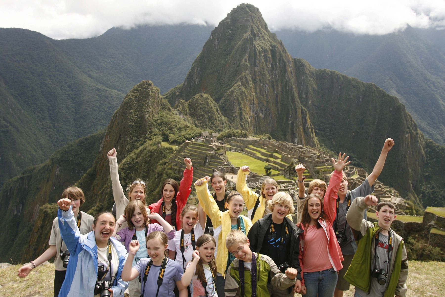 Foreign tourists visiting the Inca Citaldel of Machu Picchu, Peru.