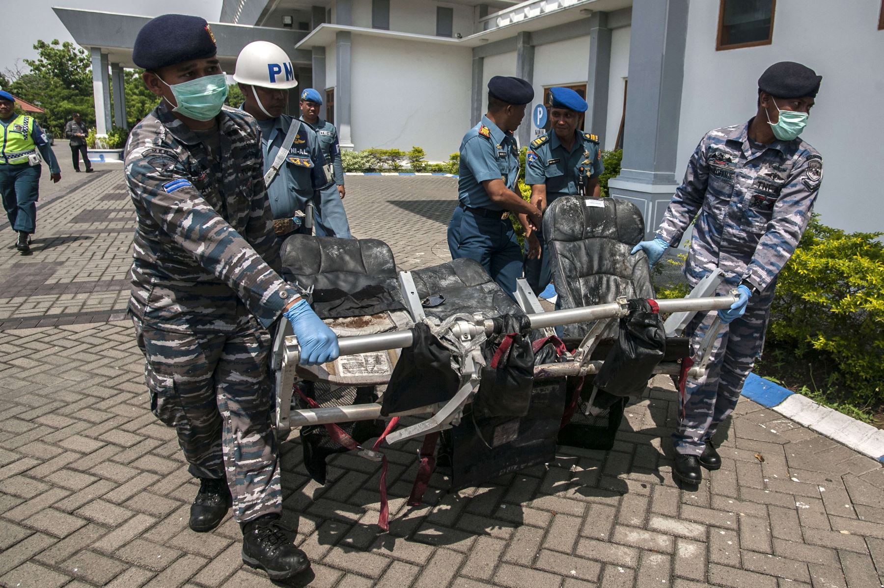 Personal militar traslada parte del avión de AirAsia recuperado del mar de Java. Foto: AFP.