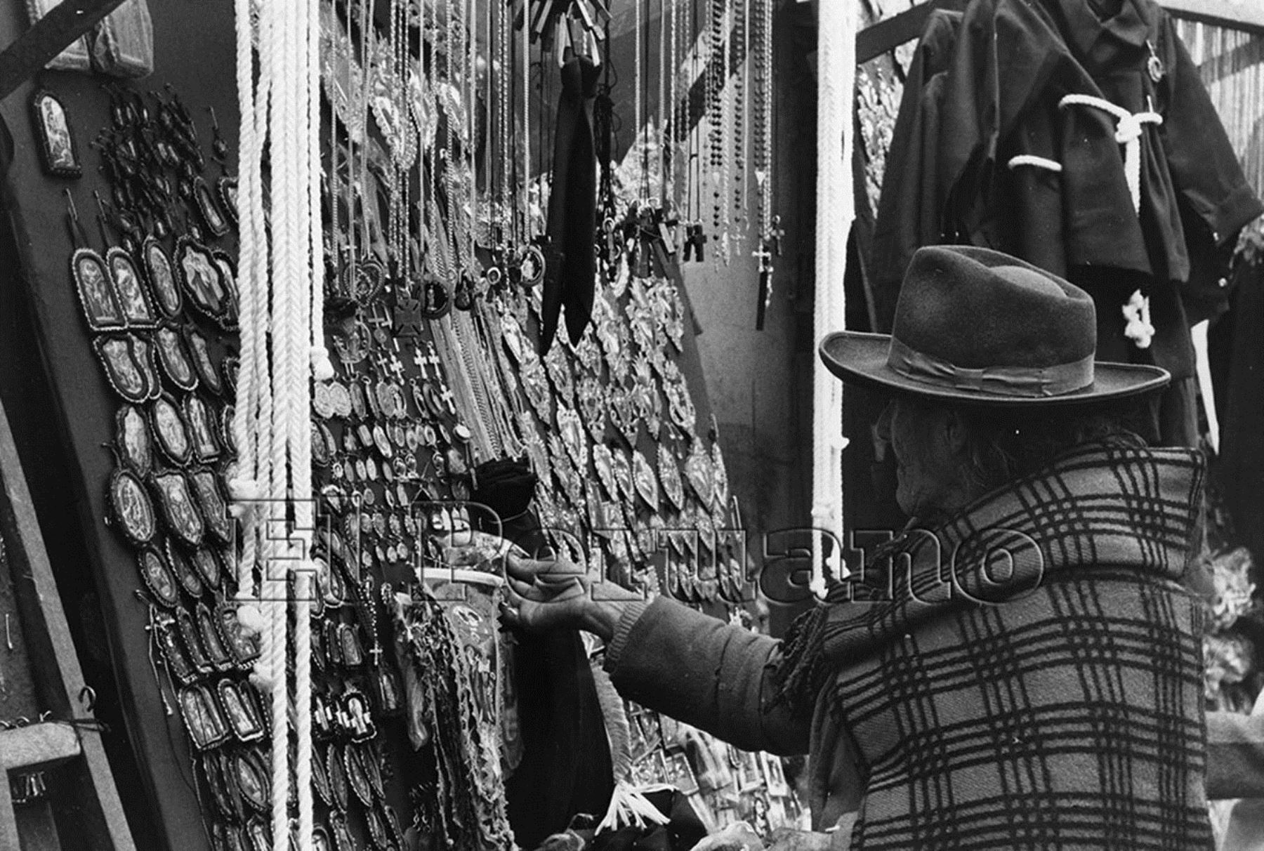 Lima - 4 Octubre 1976 / Una anciana observa los detentes o escapularios que  comercializan los ambulantes en las inmediaciones de la Iglesia las Nazarenas en el mes del Señor de los Milagros.