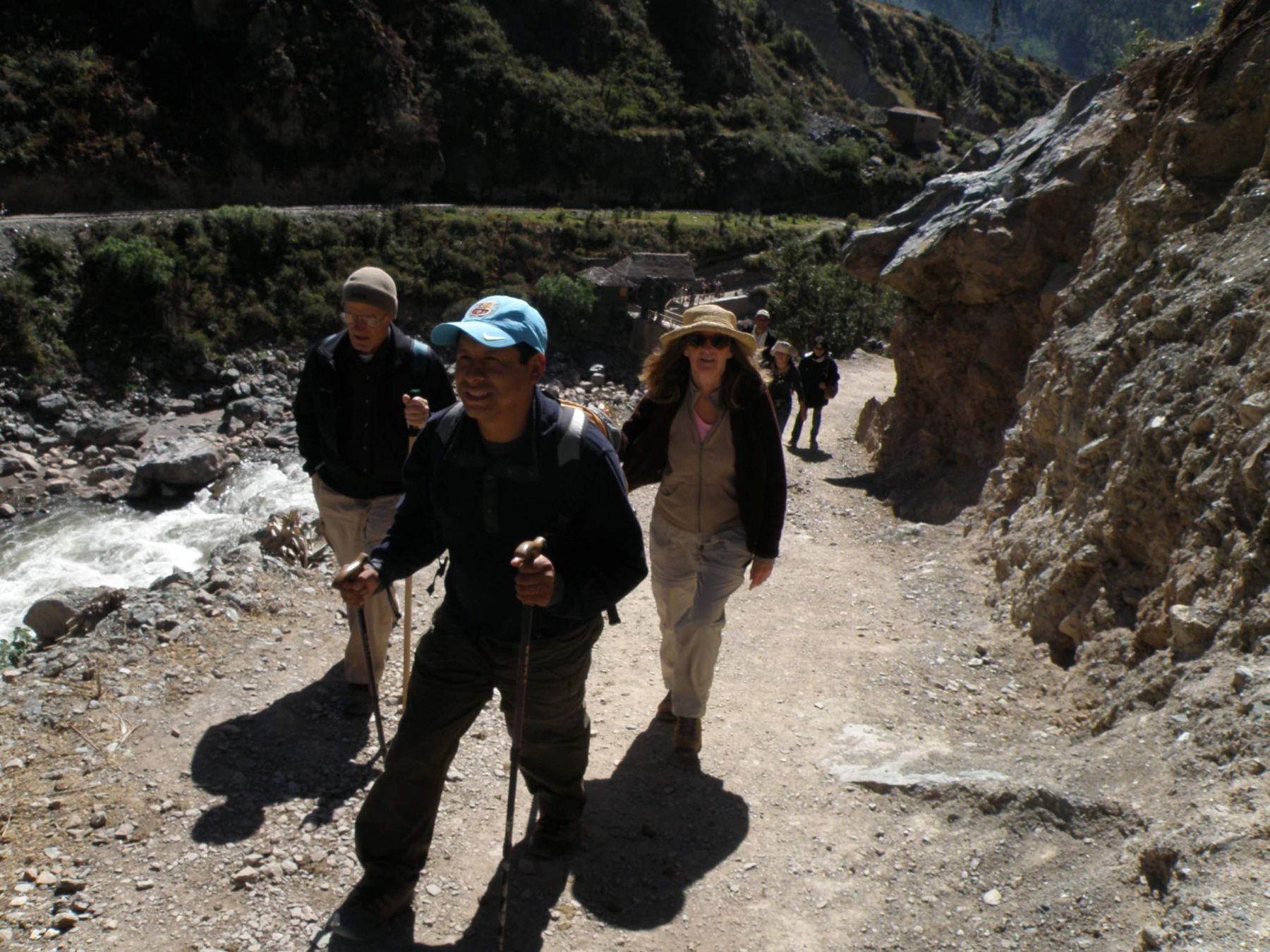 Tourists walking on an stretch of the Andean road system known as Qhapaq Nan roads