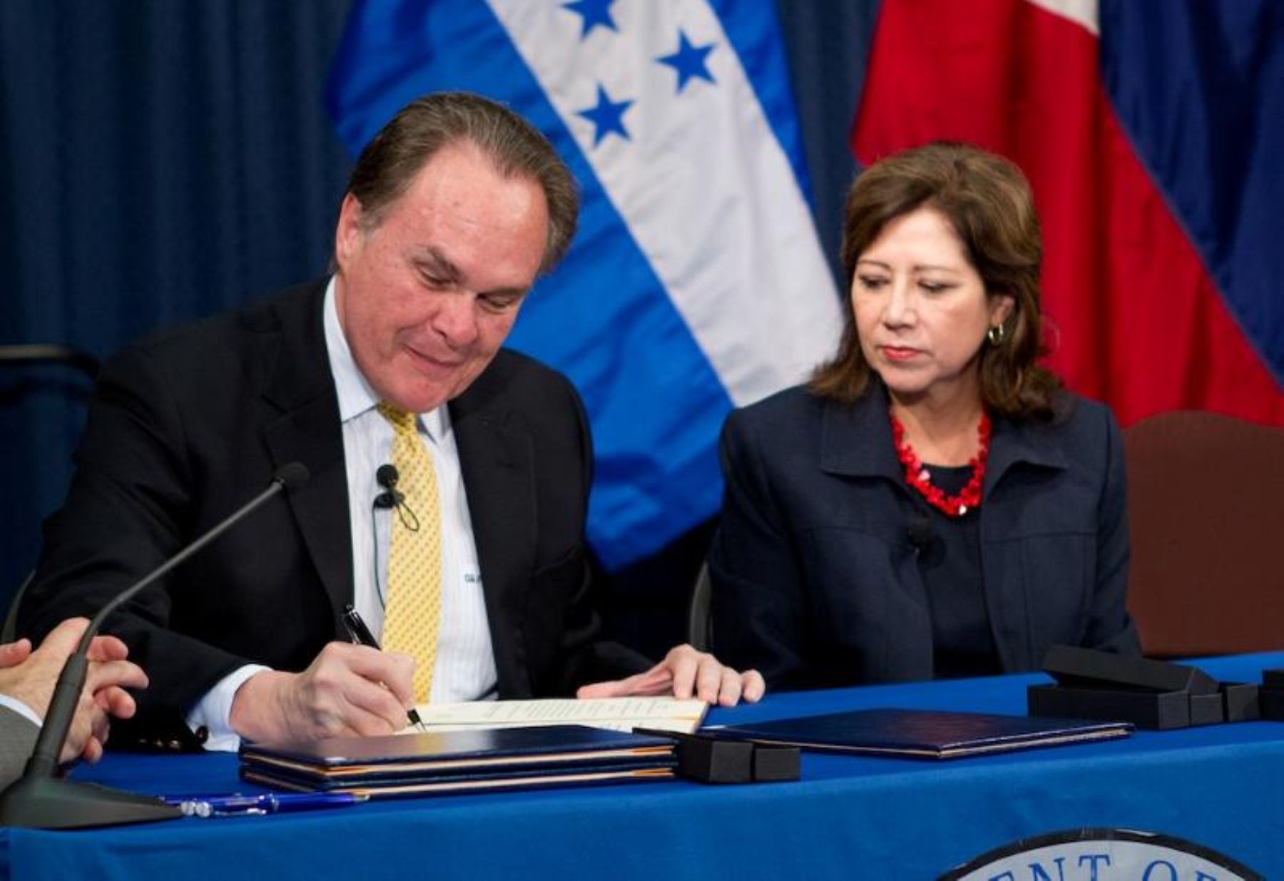 Peruvian Ambassador Harold Forsyth and Secretary of Labor Hilda L. Solis sign the agreement in Washington.