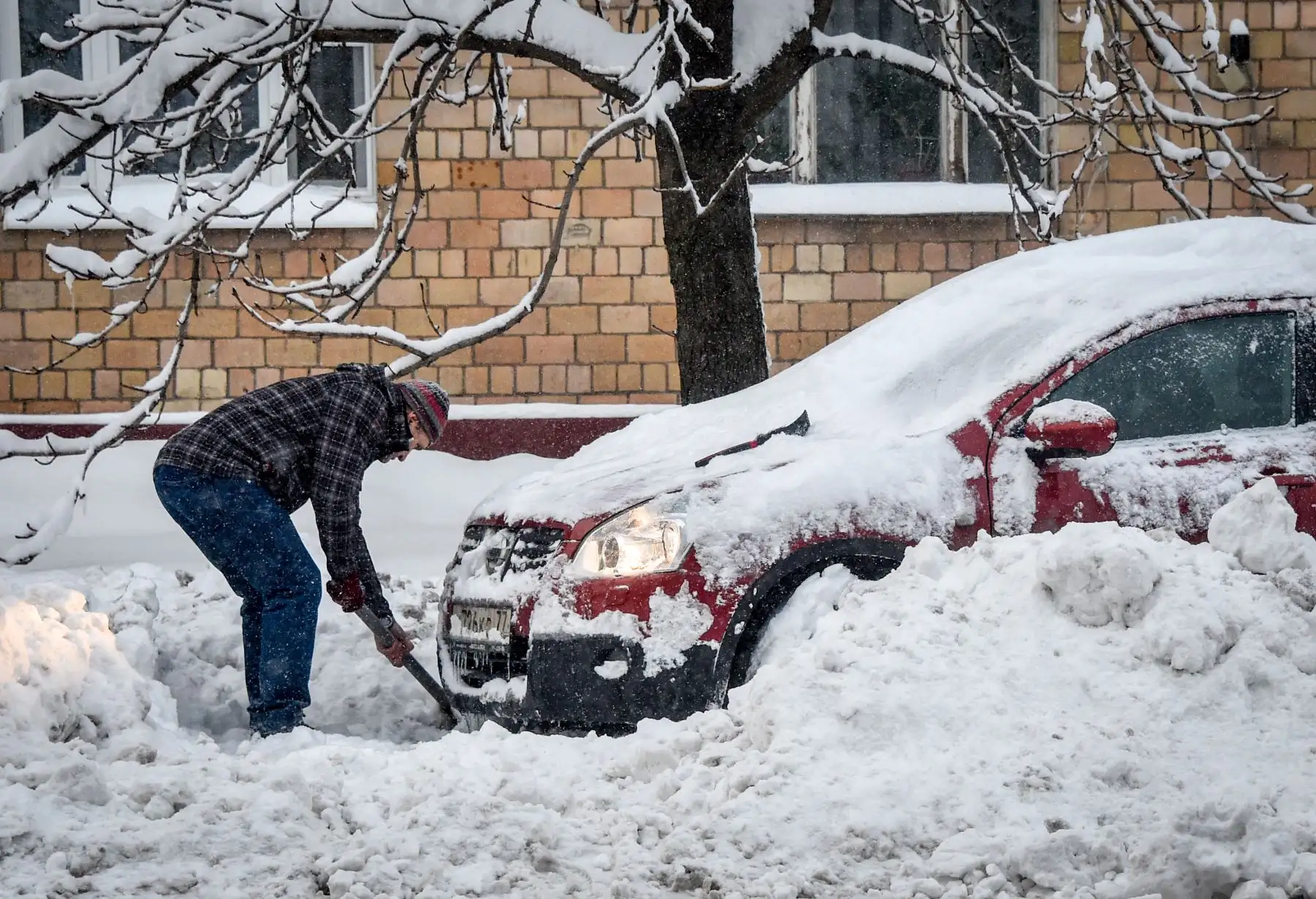 Un hombre saca su automóvil después de una tormenta de nieve en Moscú. Foto: AFP
