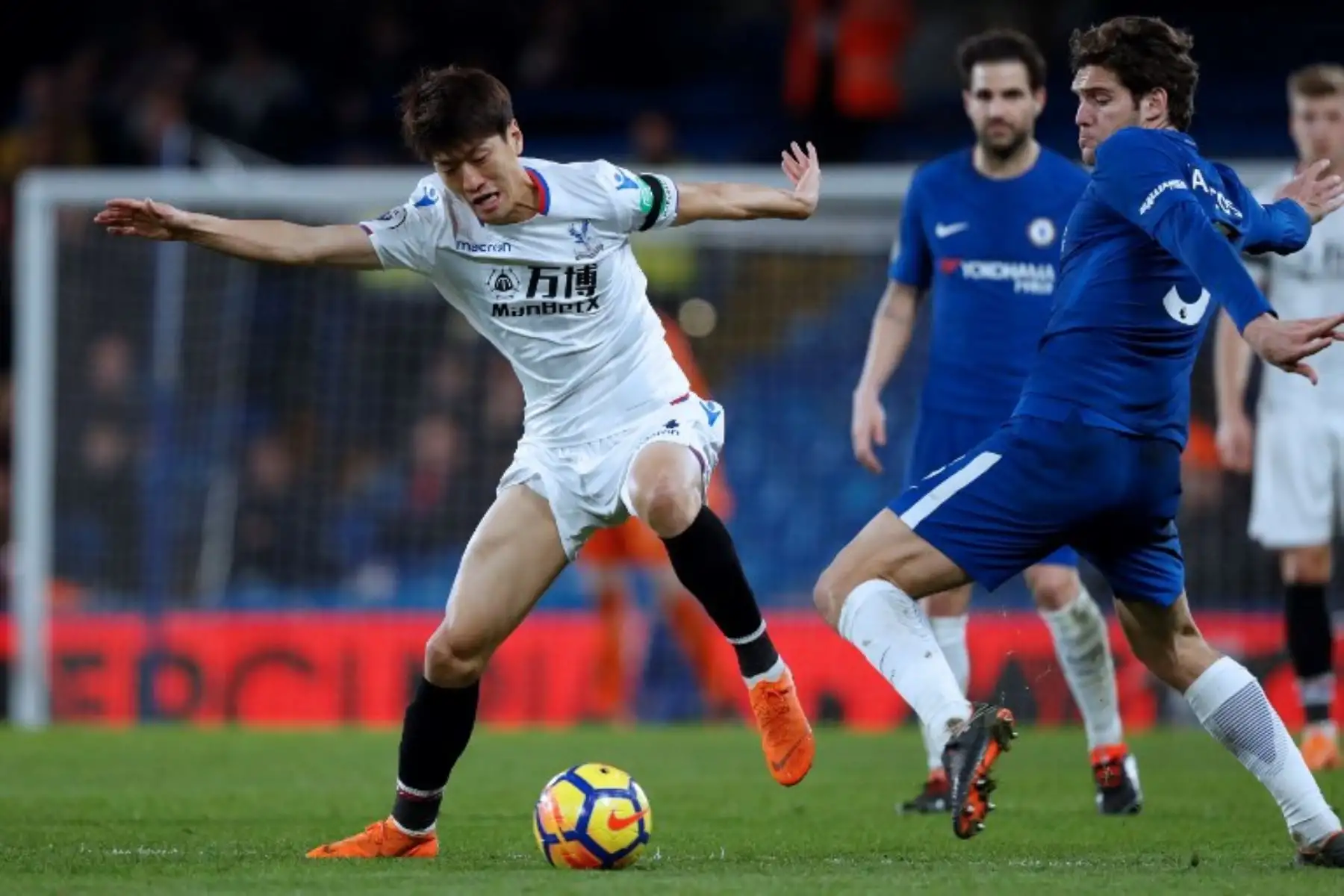 El centrocampista surcoreano Lee Chung-yong de Crystal Palace enfrenta al defensa español Chelsea Alonso durante el partido de fútbol de la Premier League inglesa entre Chelsea y Crystal .Foto.afp