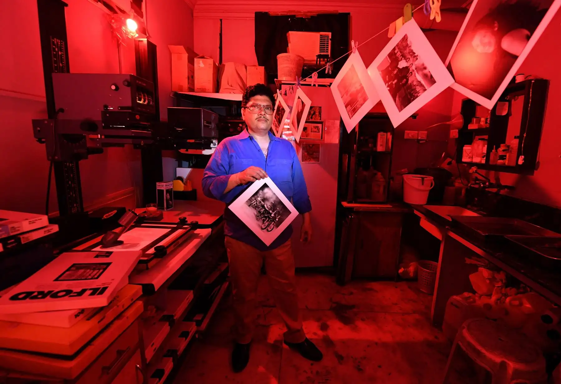 Vicky Luthra, posa con una impresión en blanco y negro en el cuarto oscuro en sus estudios de impresión SV Photographic en Nueva Delhi. Foto: AFP