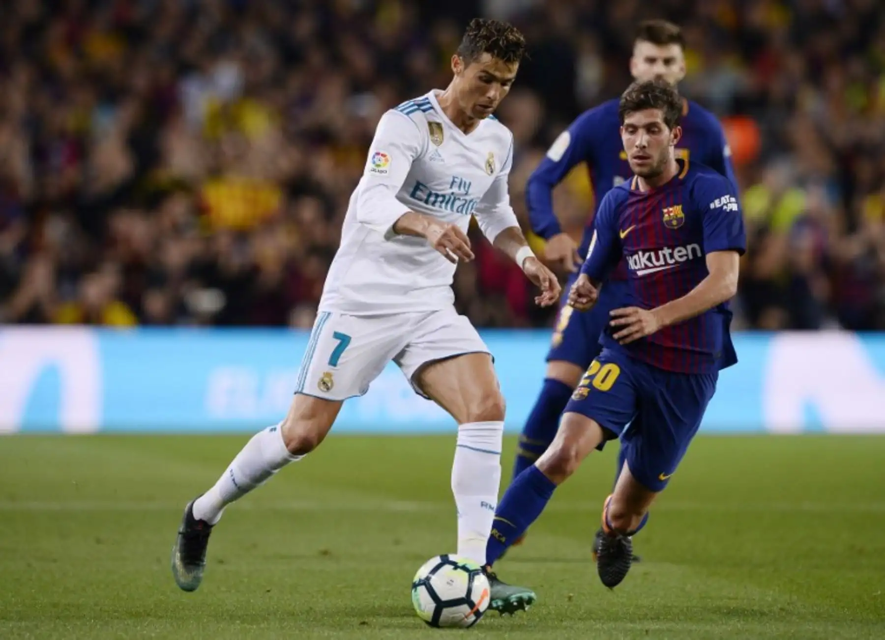 El delantero portugués del Real Madrid Cristiano Ronaldo, compite con el centrocampista español del Barcelona Sergi Roberto durante el partido de fútbol de la liga española.Foto:AFP