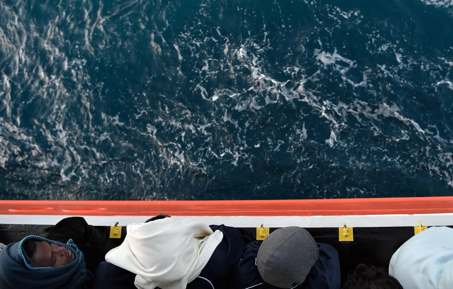 Miigrantes  en la cubierta del MV Aquarius, un buque de rescate fletado por SOS-Mediterranee y Médicos Sin Fronteras, mientras se acerca a la costa italiana. AFP