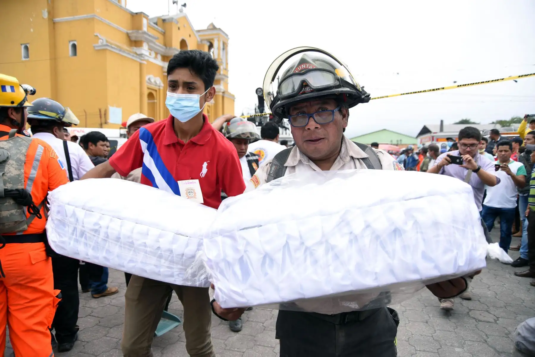 Los bomberos voluntarios llevan a la morgue los ataúdes con los remais de dos niños, que murieron después de la erupción del volcán Fuego, en el municipio de Alotenango, Sacatepéquez, a unos 65 km al suroeste de Guatemala.Foto:AFP