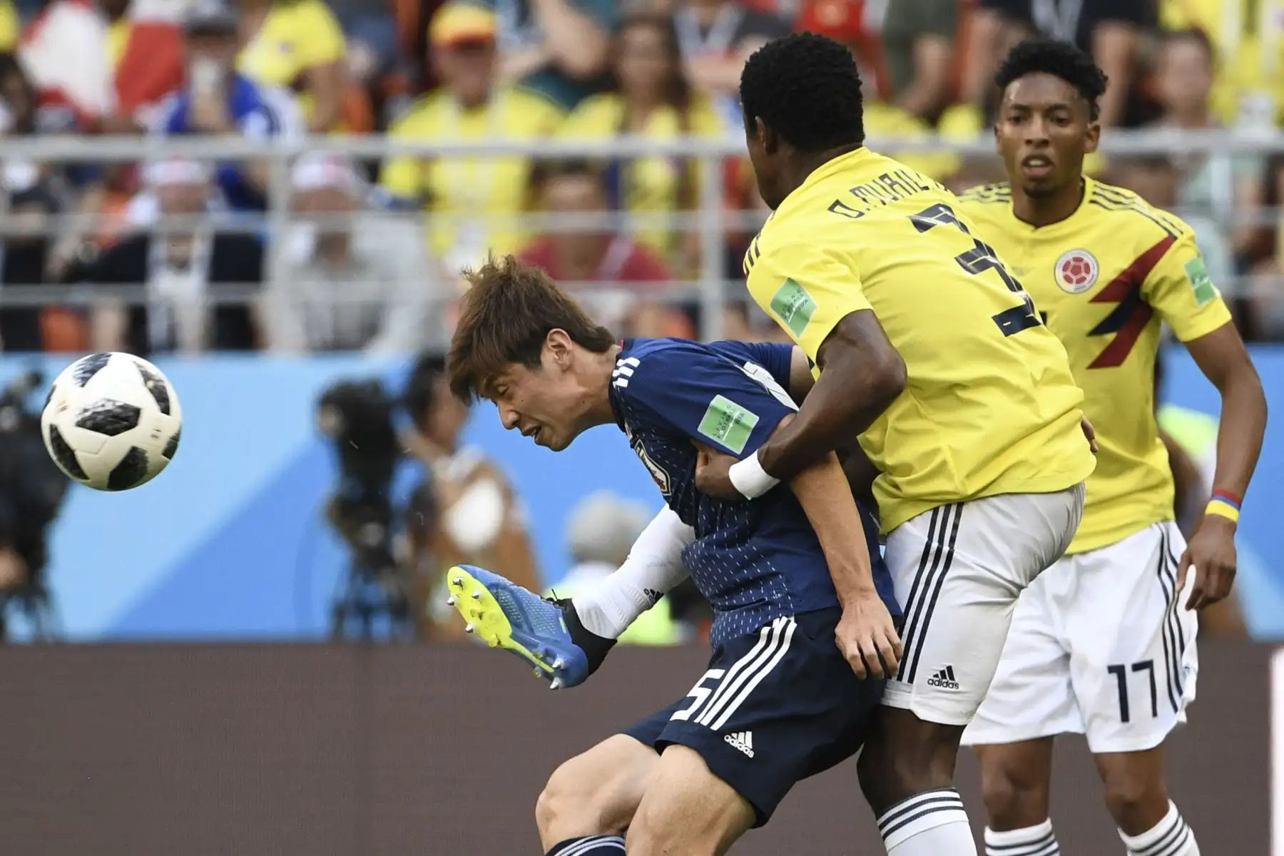 La delantera japonesa Yuya Osako (L) reta al defensor colombiano Oscar Murillo (C) y al defensor colombiano Johan Mojica (R) durante el partido de fútbol del Grupo H Rusia 2018 entre Colombia y Japón en el Mordovia Arena en Saransk el 19 de junio de 2018. / AFP