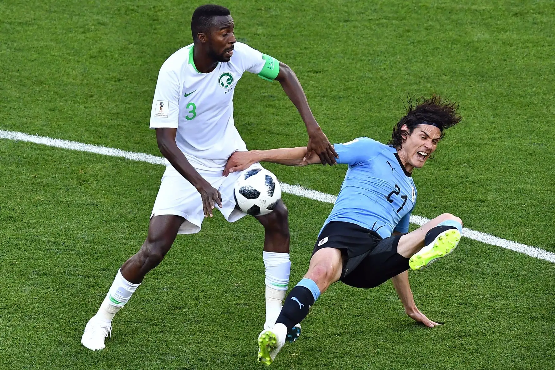El delantero uruguayo Edinson Cavani (R) lucha por el balón con el defensa de Arabia Saudita Osama Hawsawi durante el partido de fútbol del Grupo A de la Copa Mundial Rusia 2018 entre Uruguay y Arabia Saudita en el Rostov Arena en Rostov-On-Don el 20 de junio de 2018. / AFP