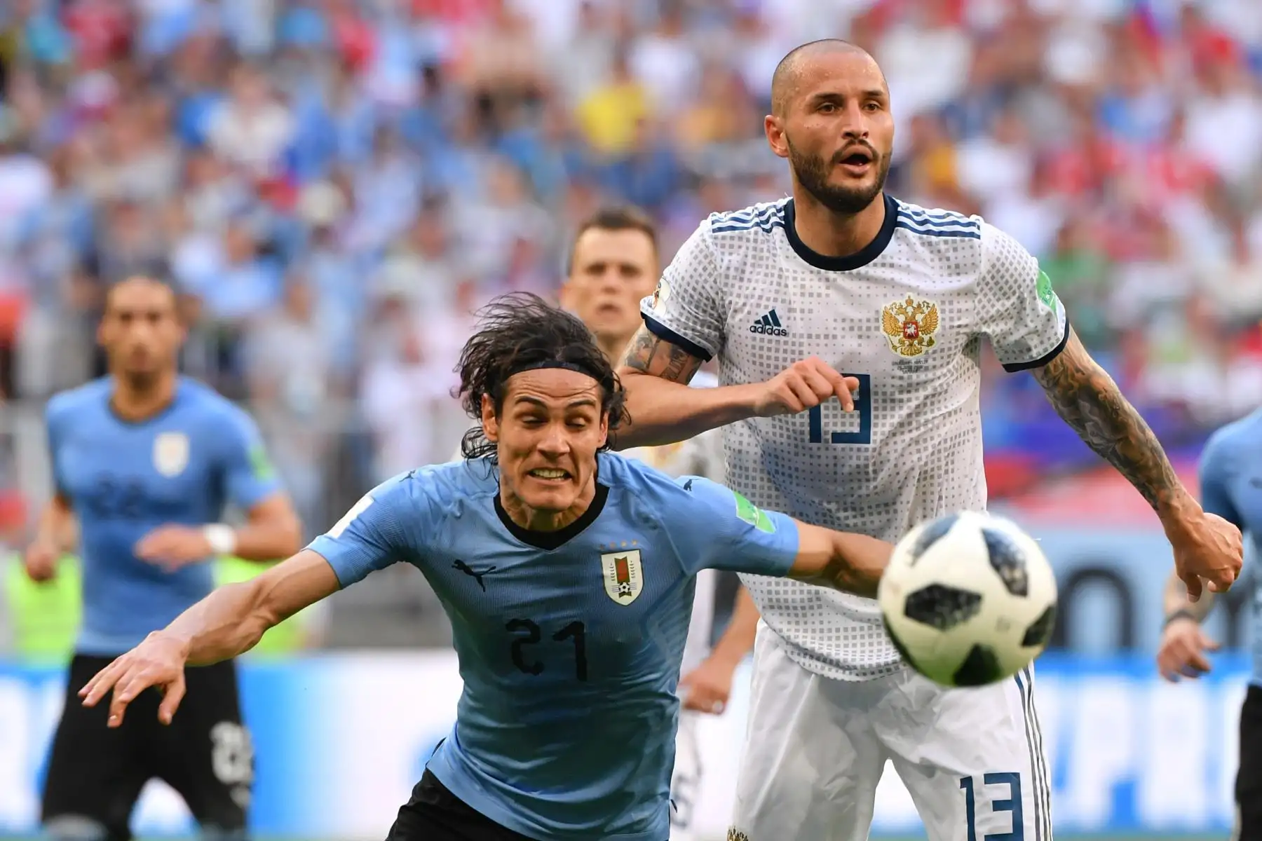 El defensor ruso Fyodor Kudryashov (R) encabeza el balón con el delantero uruguayo Edinson Cavani durante el partido de fútbol del Grupo A de la Copa Mundial Rusia 2018 entre Uruguay y Rusia en el Samara Arena en Samara el 25 de junio de 2018. / AFP