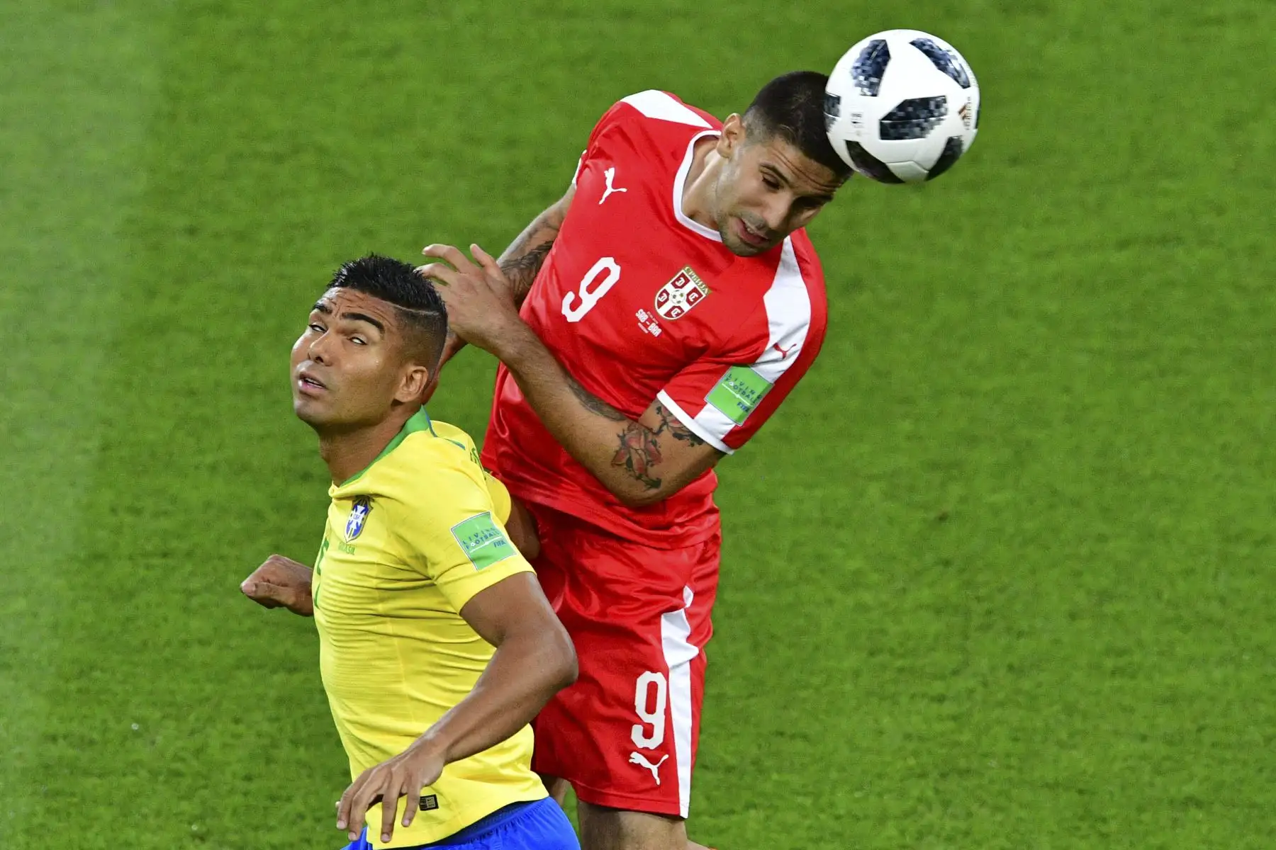 El alero serbio Aleksandar Mitrovic (R) encabeza el balón detrás del centrocampista brasileño Casemiro durante el partido de fútbol del Grupo E de la Copa Mundial Rusia 2018 entre Serbia y Brasil en el Estadio Spartak de Moscú el 27 de junio de 2018. / AFP
