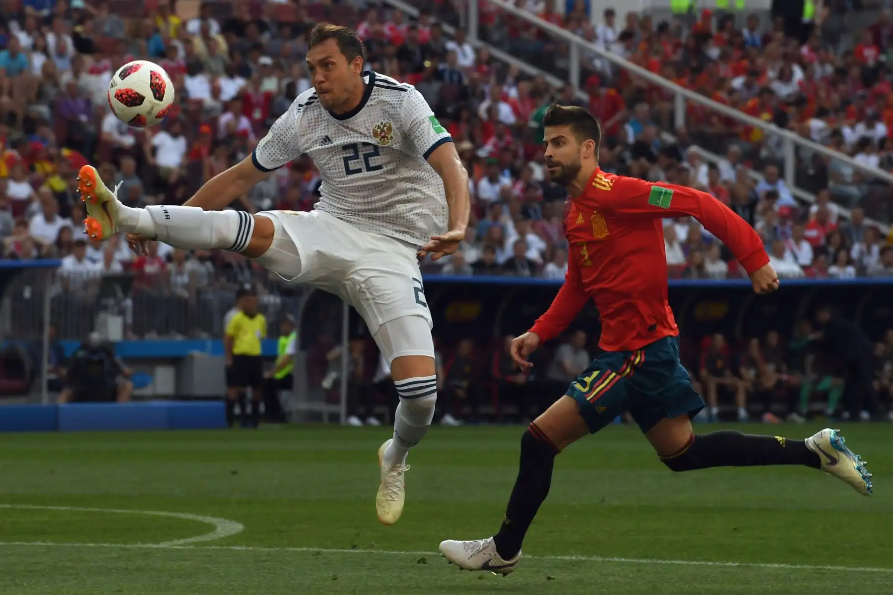 El delantero ruso Artem Dzyuba (L) compite con el defensa español Gerard Piqué durante la ronda de rondas 16 de la Copa Mundial Rusia 2018 entre España y Rusia en el Estadio Luzhniki de Moscú el 1 de julio de 2018. / AFP