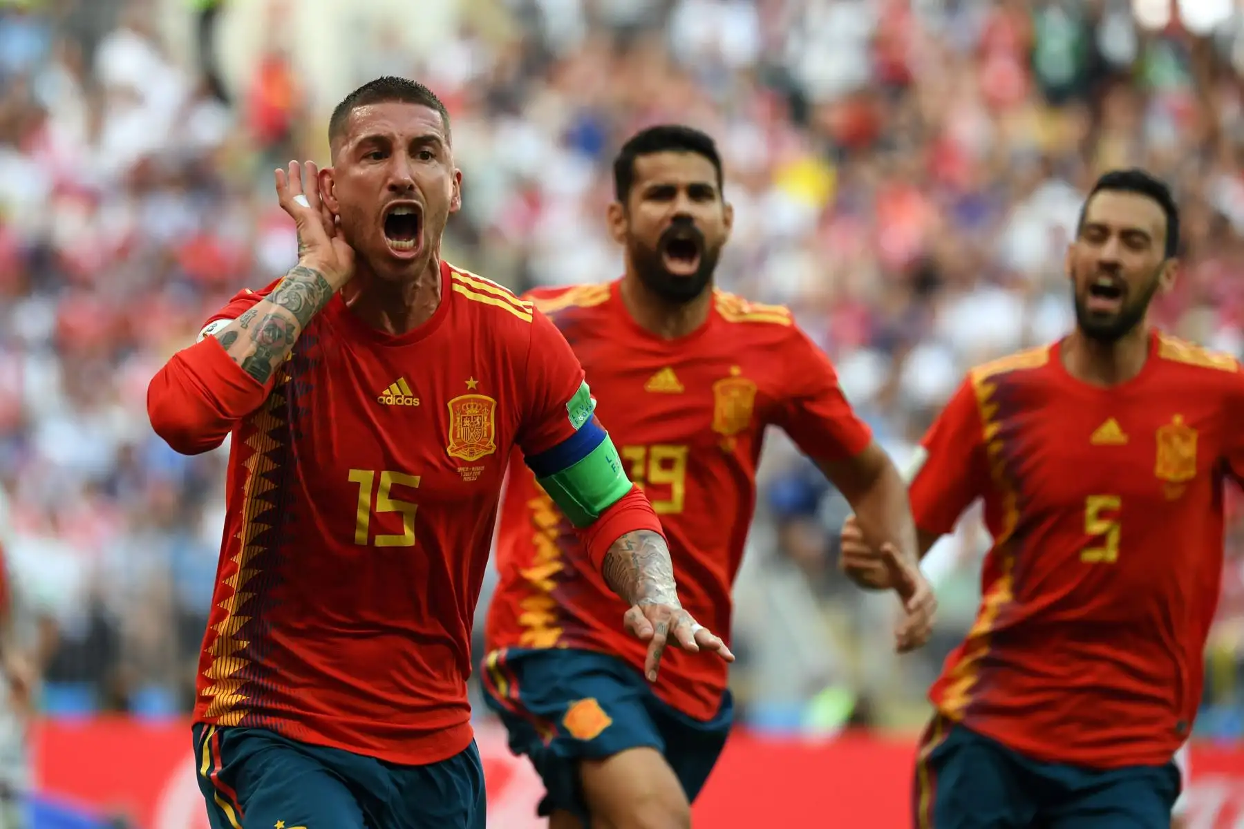 El defensa español Sergio Ramos (L) celebra al delantero español Diego Costa (C) y al centrocampista español Sergio Busquets después de un gol en propia puerta del defensor ruso Sergey Ignashevich durante la ronda de octavos de final de la Copa Mundial Rusia 2018 entre España y Rusia en el Estadio Luzhniki en Moscú el 1 de julio de 2018. / AFP