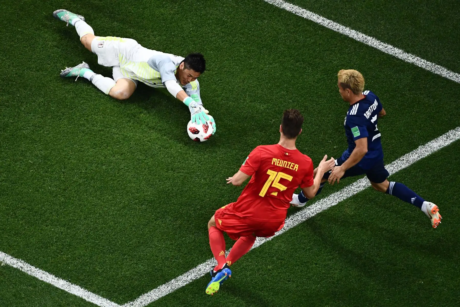 El portero japonés Eiji Kawashima (L) detiene un tiro a puerta del defensor belga Thomas Meunier (C) durante la ronda de octavos de final de la Copa Mundial Rusia 2018 entre Bélgica y Japón en el Rostov Arena en Rostov-On-Don el 2 de julio de 2018 . / AFP