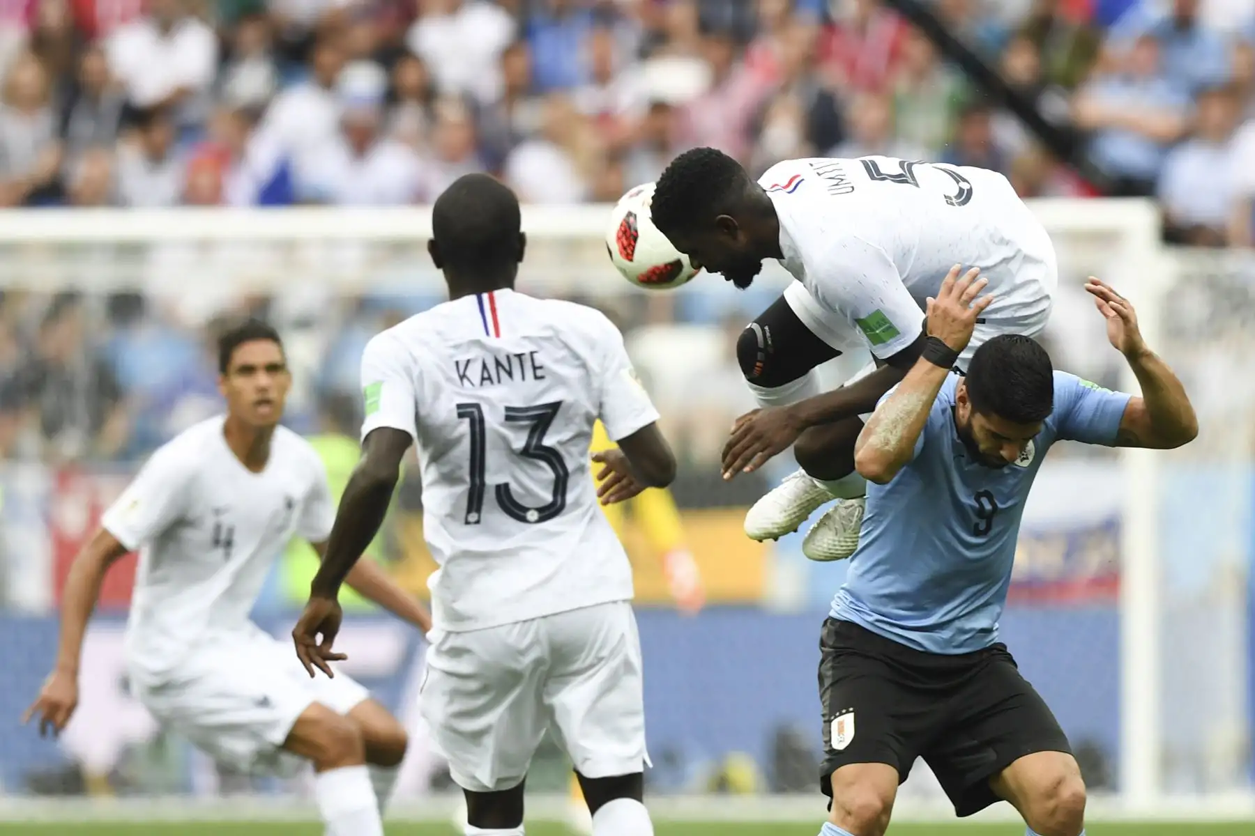 El defensa de Francia Samuel Umtiti (arriba) y el delantero uruguayo Luis Suárez compiten por el balón durante el partido de cuartos de final de la Copa Mundial Rusia 2018 entre Uruguay y Francia en el Estadio Nizhny Novgorod en Nizhny Novgorod el 6 de julio de 2018. / AFP