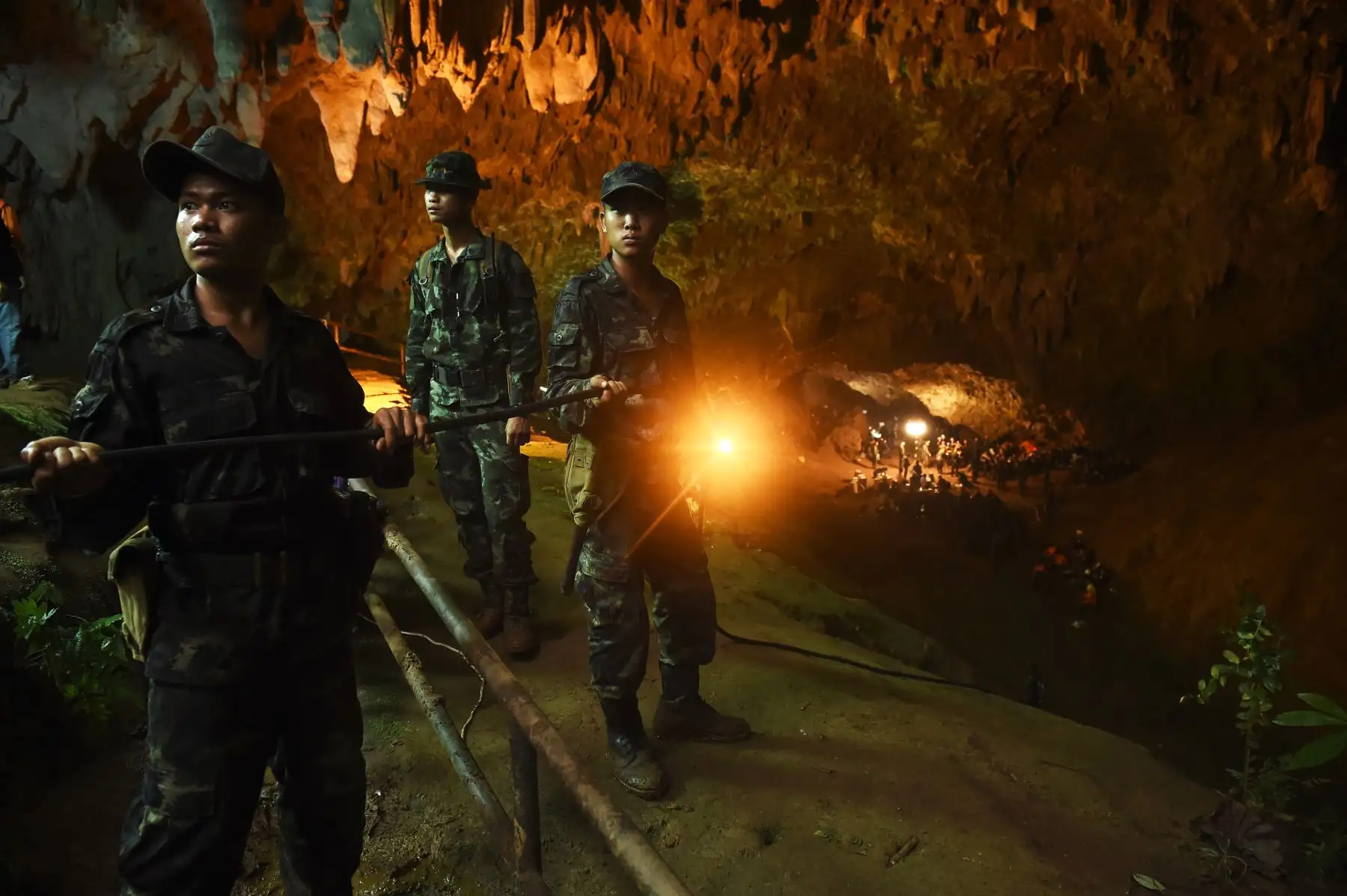 Los soldados tailandeses transmiten el cable eléctrico a la cueva de Tham Luang en el Parque Forestal Khun Nam Nang en Chiang, durante una operación de rescate de un equipo de fútbol para niños desaparecidos y su entrenador.AFP