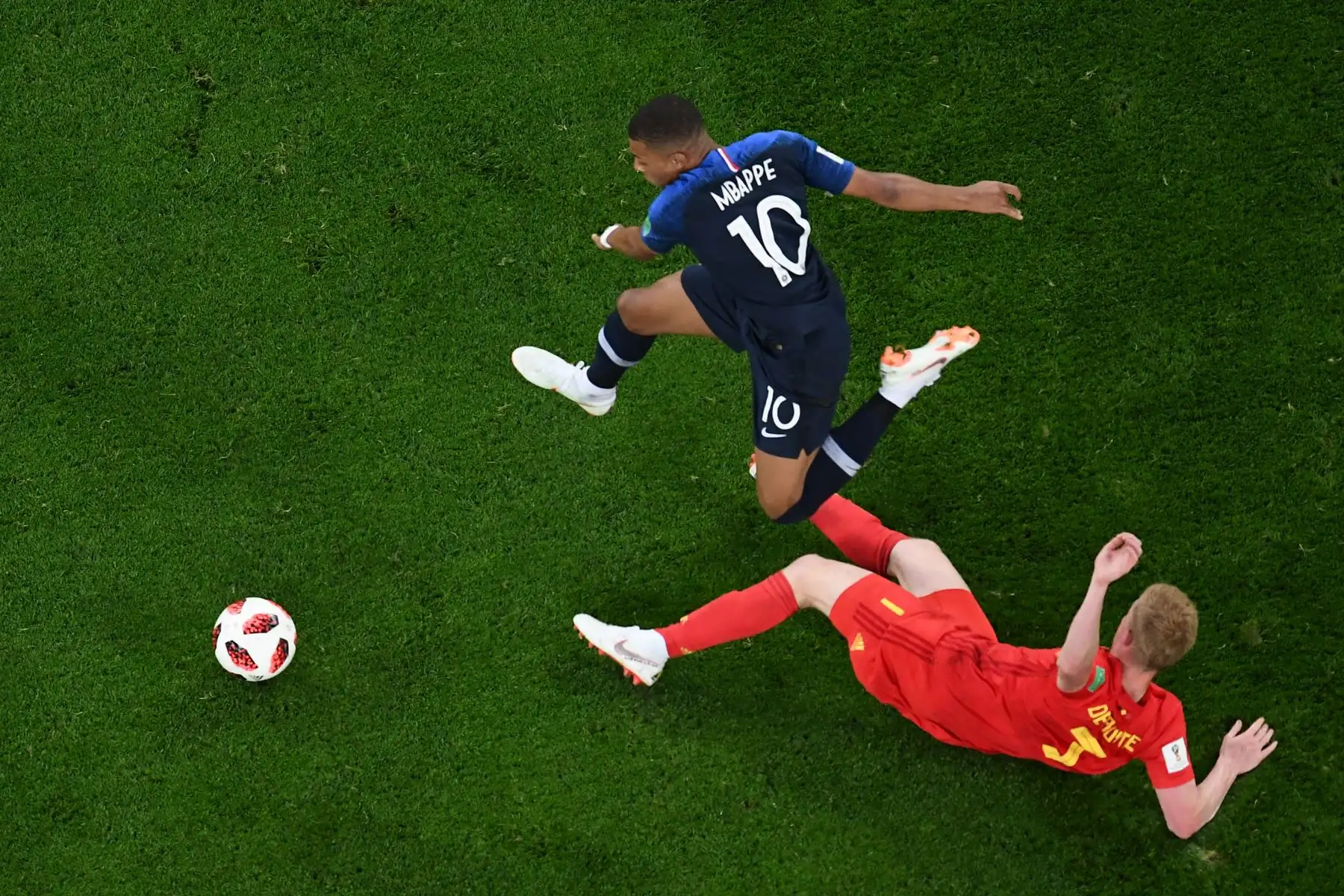 El centrocampista belga Kevin De Bruyne (R) compite por el balón con el delantero francés Kylian Mbappe durante el partido de semifinales de la Copa Mundial Rusia 2018 entre Francia y Bélgica en el estadio de San Petersburgo el 10 de julio de 2018. / AFP