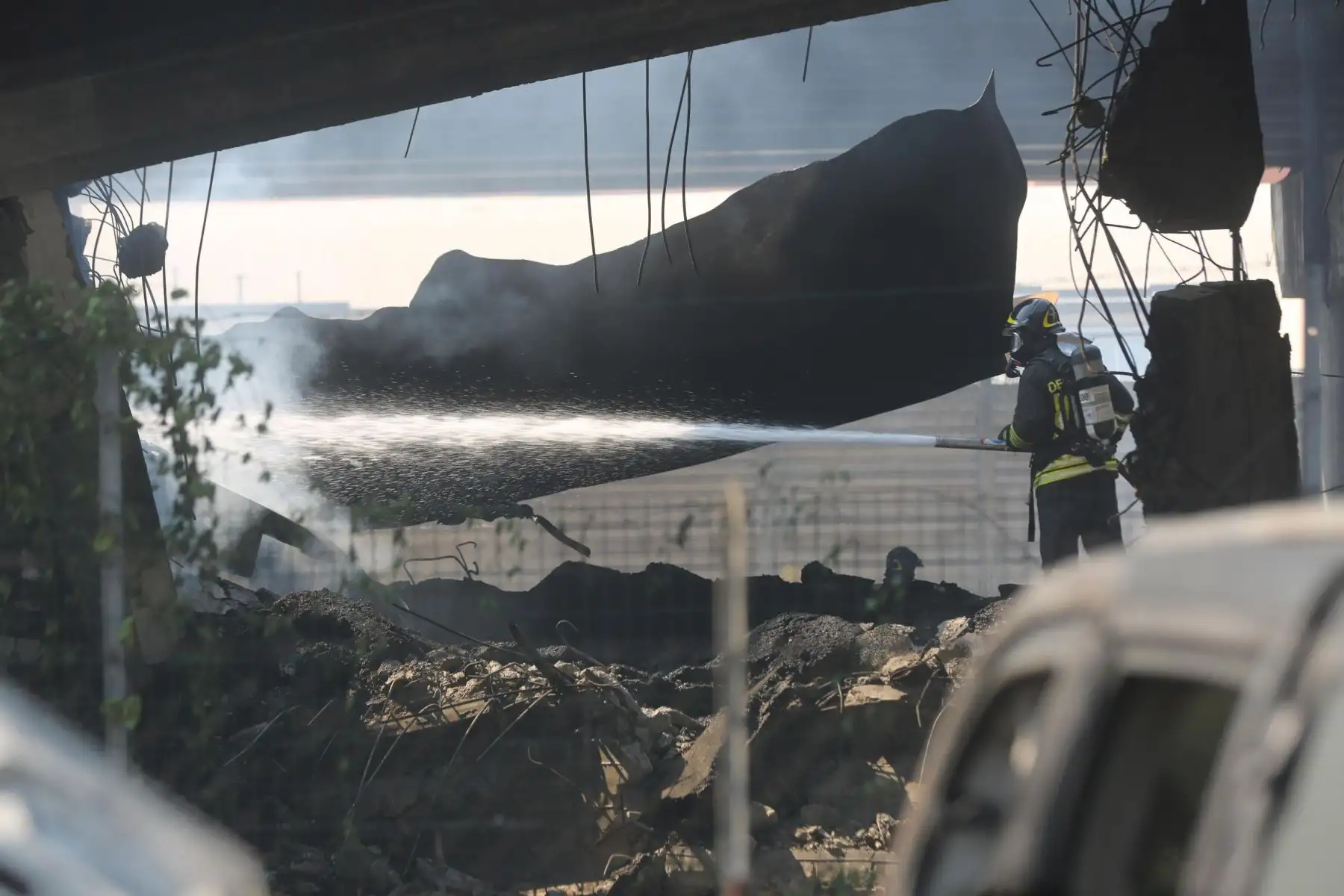 EPA5303. BOLONIA (ITALIA), 06/08/2018.- Bomberos italianos tratan de extinguir las llamas en el puente de la autopista del cruce Casalecchio A1-A14 después de un accidente de transito en Bolonia, Italia, hoy, 6 de agosto de 2018. Al menos una persona ha fallecido y más de 60 resultaron heridas tras la explosión de un camión cisterna con material inflamable en la autovía de la ciudad italiana de Bolonia (centro), confirmaron a Efe fuentes de la Jefatura de policía. EFE