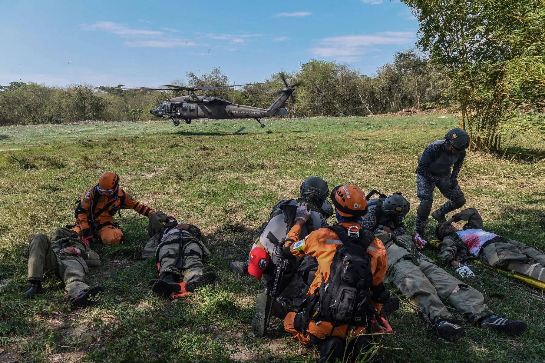 Equipos colombianos de rescate y tropas de la Fuerza Aérea esperan un helicóptero como parte de un ejercicio de simulación de terremotos realizado por tropas de la Fuerza Aérea de Colombia, República Dominicana, Perú, Brasil y Estados Unidos en la base de la Fuerza Aérea Palenquero en Puerto Salgar, departamento de Cundinamarca. Colombia, el 6 de septiembre de 2018.
Equipos de la Fuerza Aérea de 12 países participaron en los ejercicios "Ángel de los Andes", donde simularon varias operaciones de rescate en diferentes escenarios. / AFP