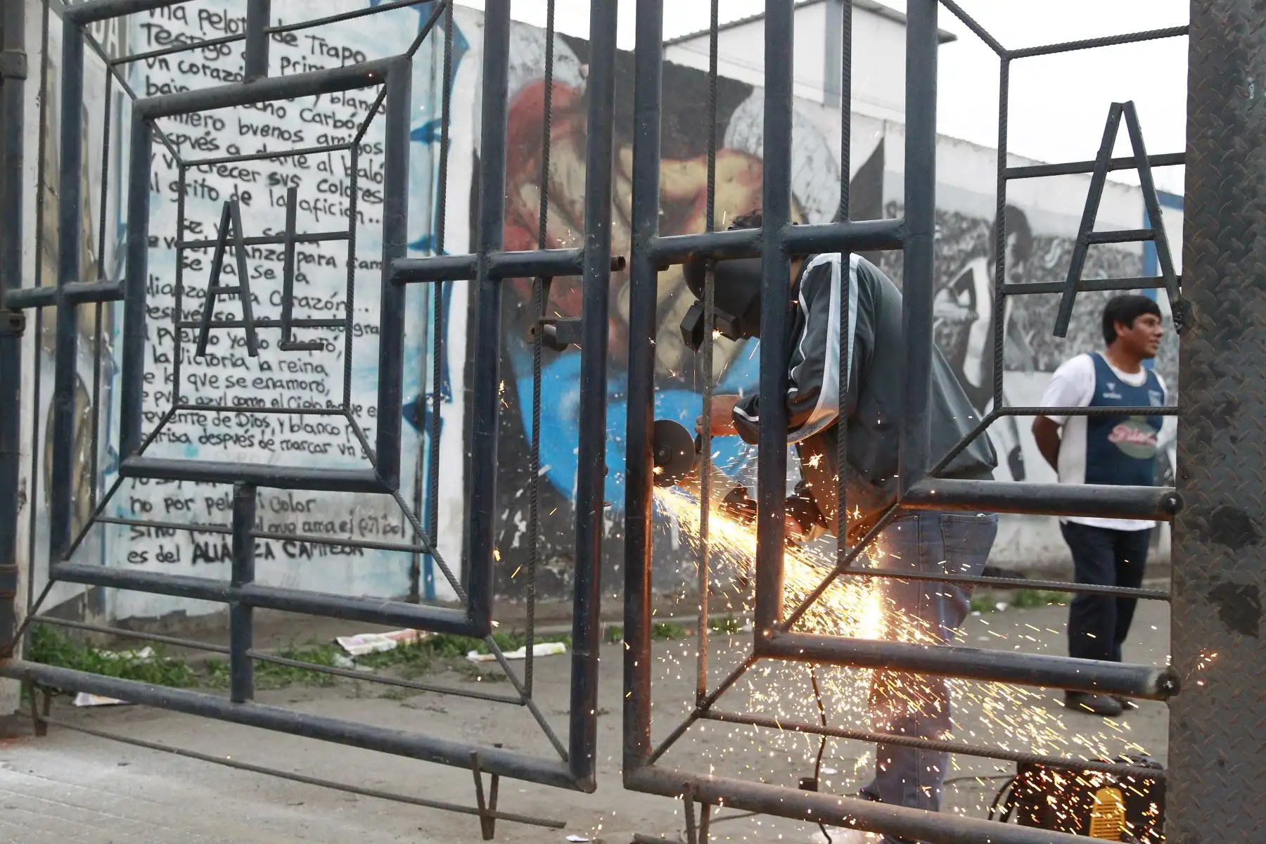 Hinchas blanquiazules reparan daños causados  tras incidente en la explanada del  estadio de Alianza Lima.Foto: ANDINA/Eddy Ramos