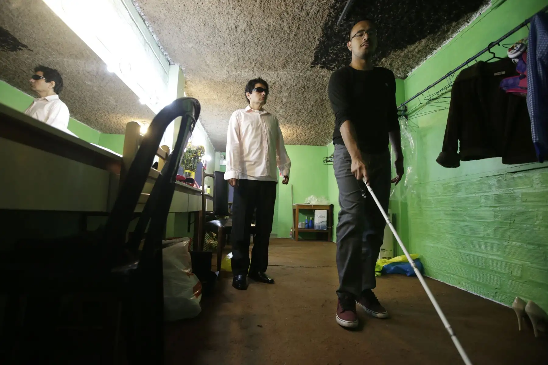 El actor Josue Parodi experimenta el usar un bastón para ciegos, mientras que su compañero de obra, Richard Picón le habla de sus vivencias como invidente.  Foto: ANDINA/Melina Mejía