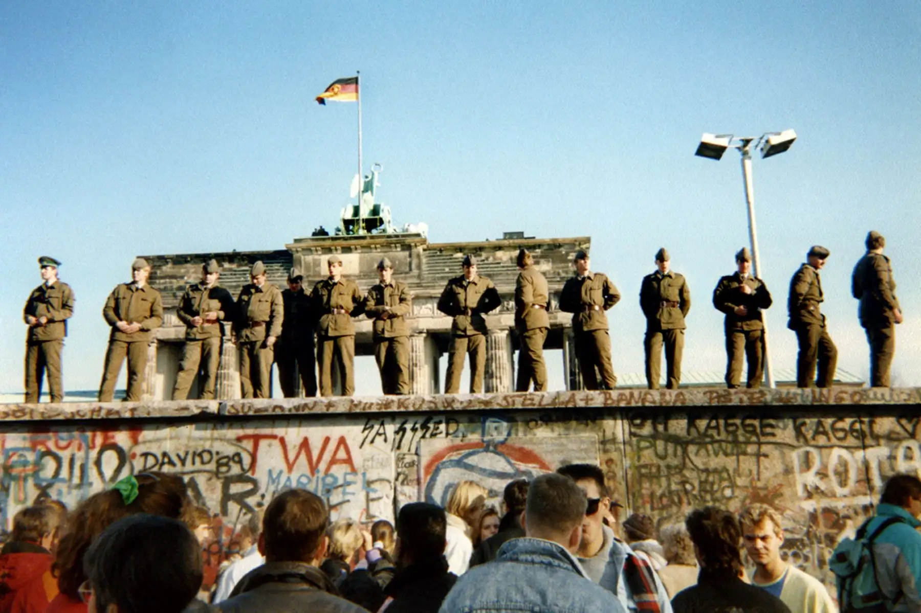 Los guardias fronterizos de Alemania del Este parados en una sección del Muro de Berlín frente a la Puerta de Brandeburgo  el 11 de noviembre de 1989. Foto: AFP