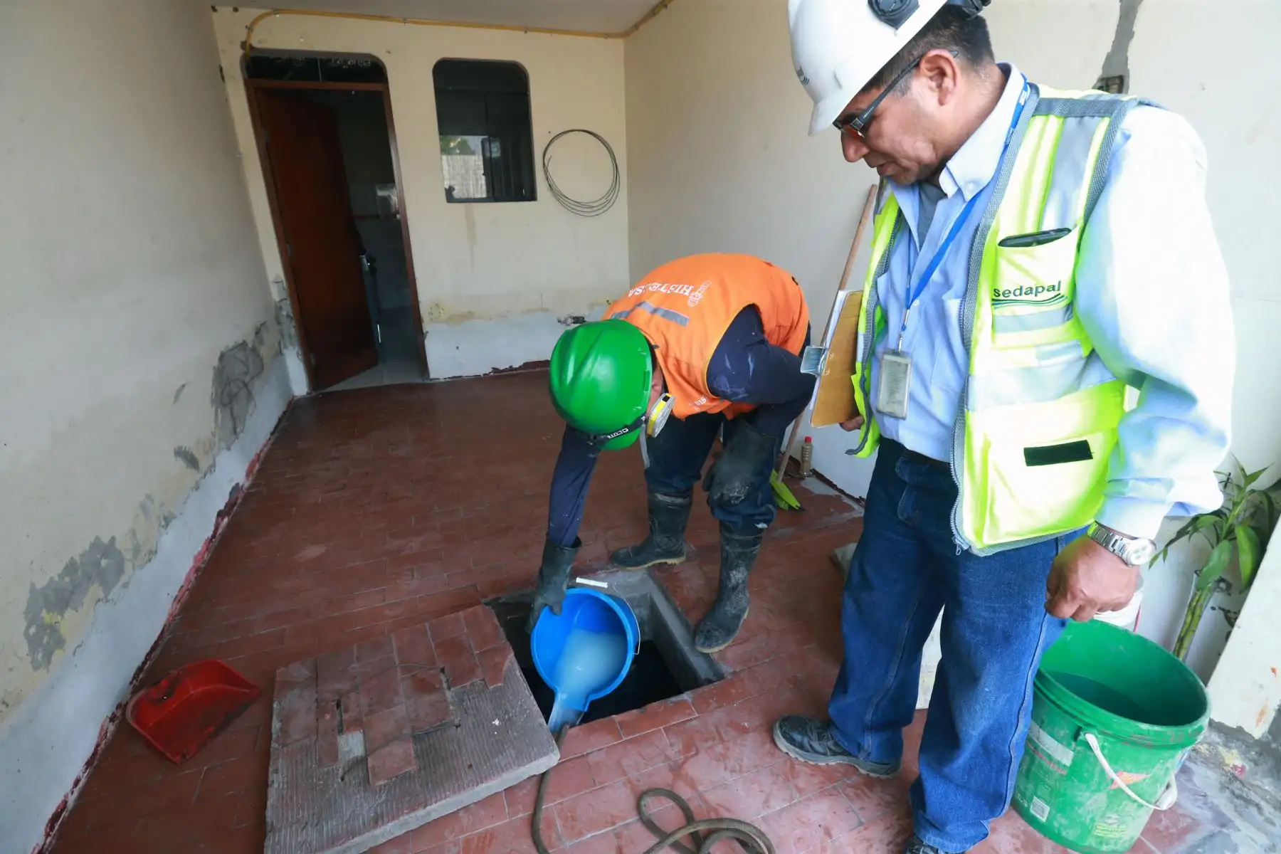 Vecinos continúa la limpieza de sus casas  afectadas por el aniego de aguas servidas, con apoyo de trabajadores del Estado. Foto: ANDINA/Norman Córdova