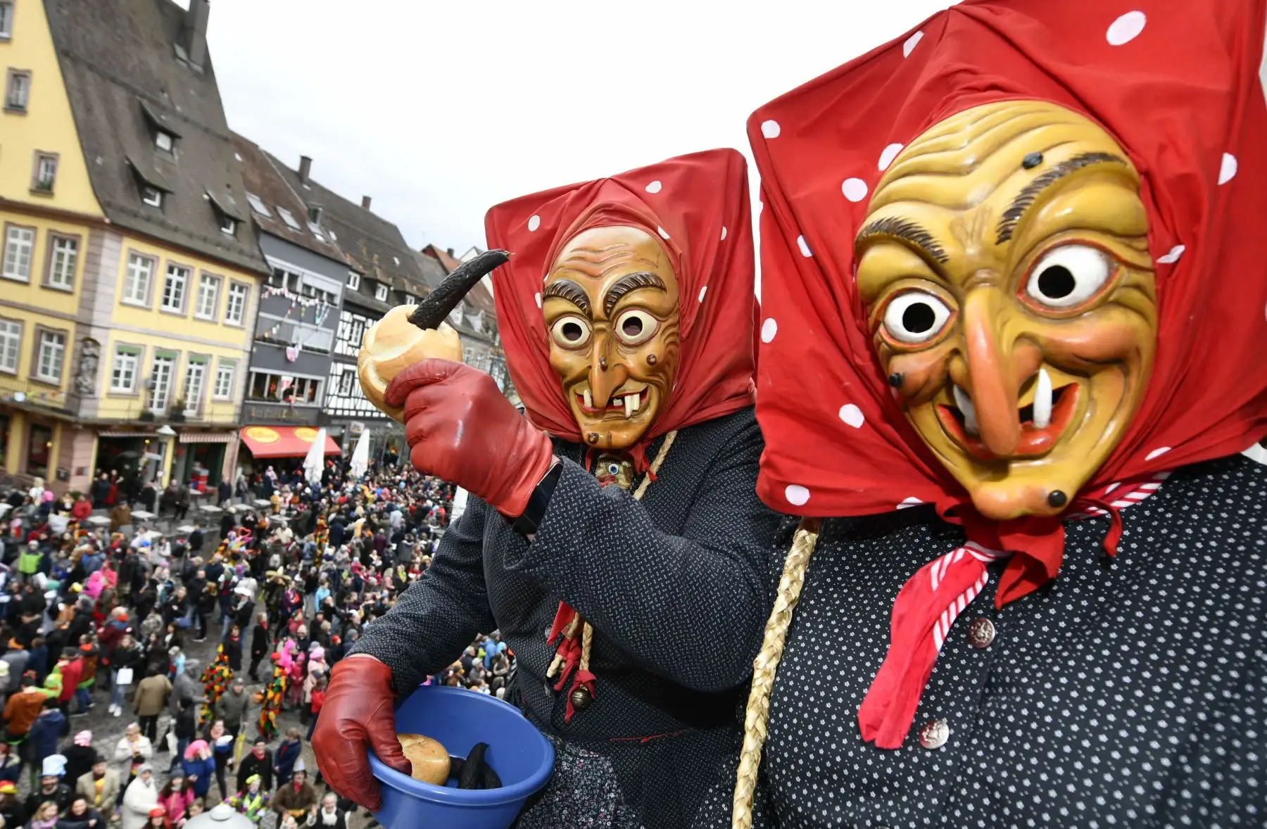 Participantes que visten trajes de brujas lanzan salchichas al público durante la tradicional "comida de brujas" en Offenburg, sur de Alemania. Foto: AFP