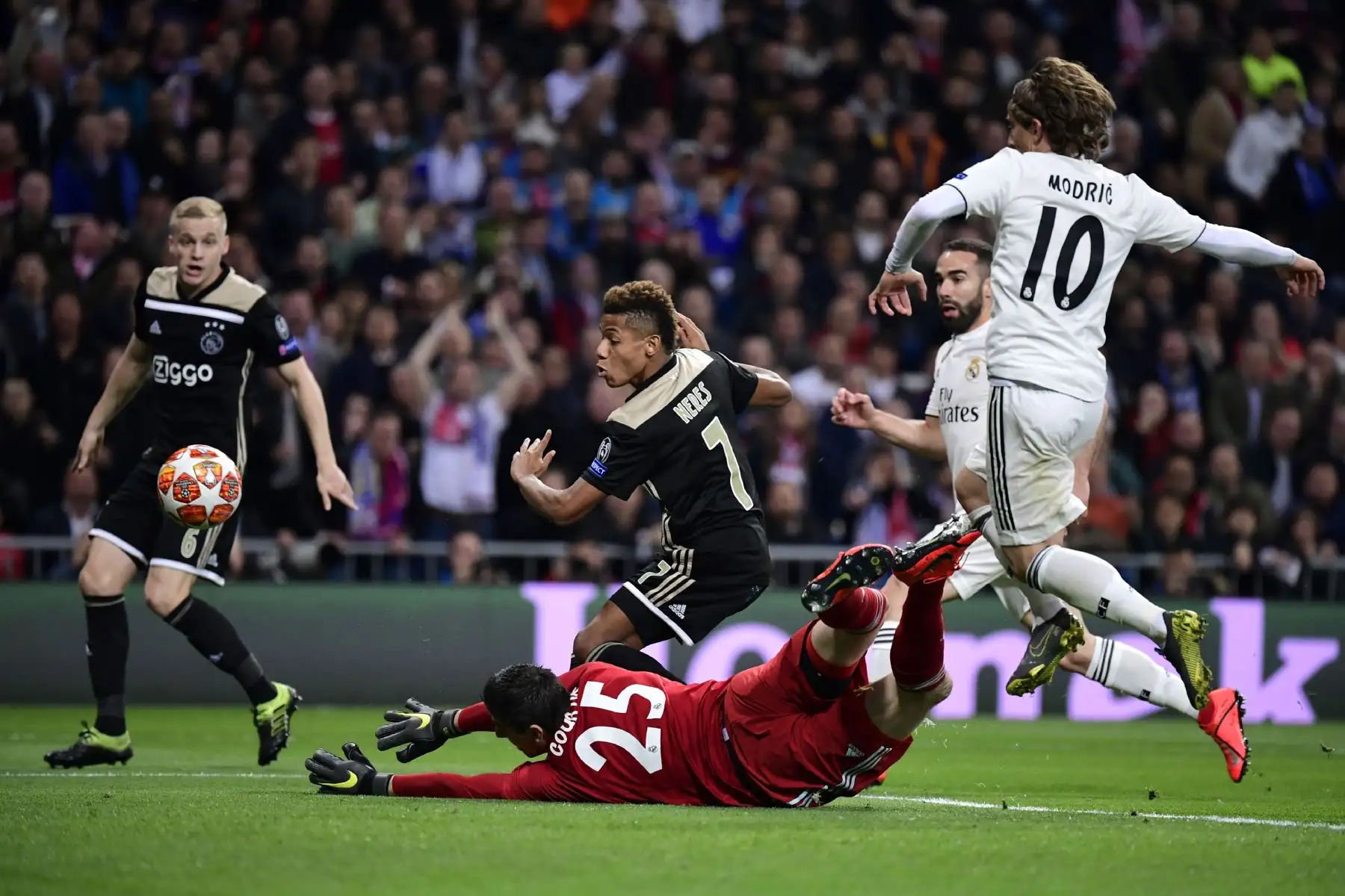 El delantero brasileño del Ajax, David Neres, anota el gol contra el portero belga del Real Madrid, Thibaut Courtois, durante la ronda de la UEFA Champions League. Foto: AFP