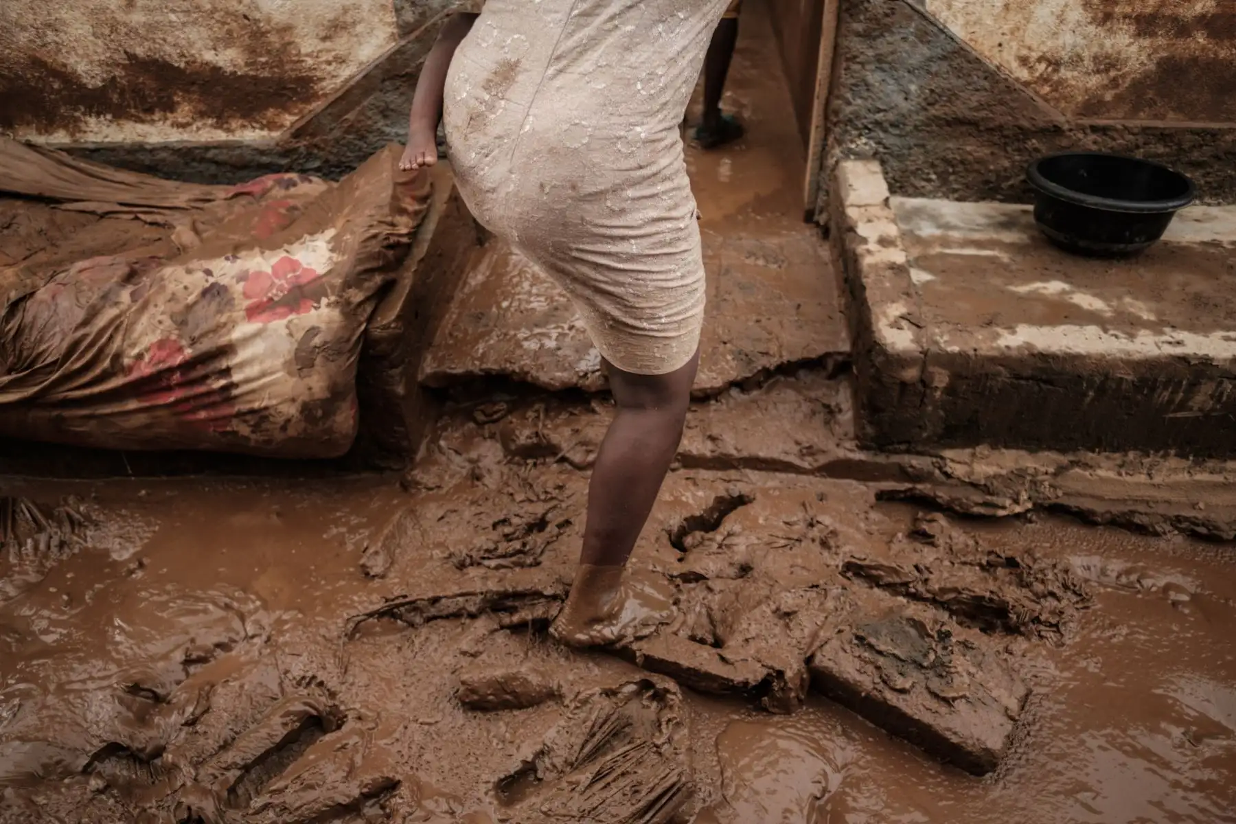 Rosa Tomas, de 27 años, ingresa a su casa cubierta de lodo en Buzi, Mozambique  luego que el área fuera golpeada por el ciclón Idai. Foto: AFP
