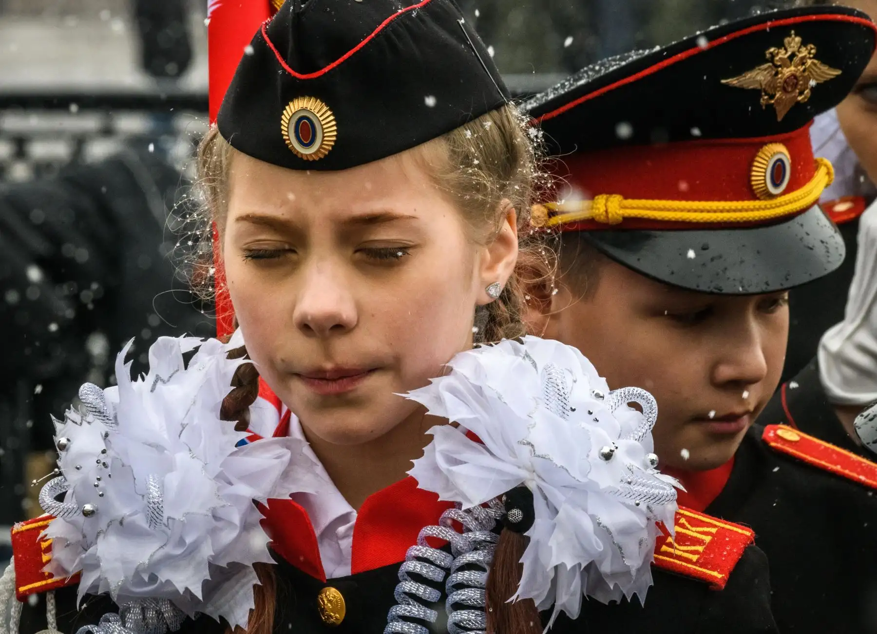 Una cadete rusa reacciona bajo la nieve durante la reunión anual de escuelas de cadetes en Moscú. Foto: AFP