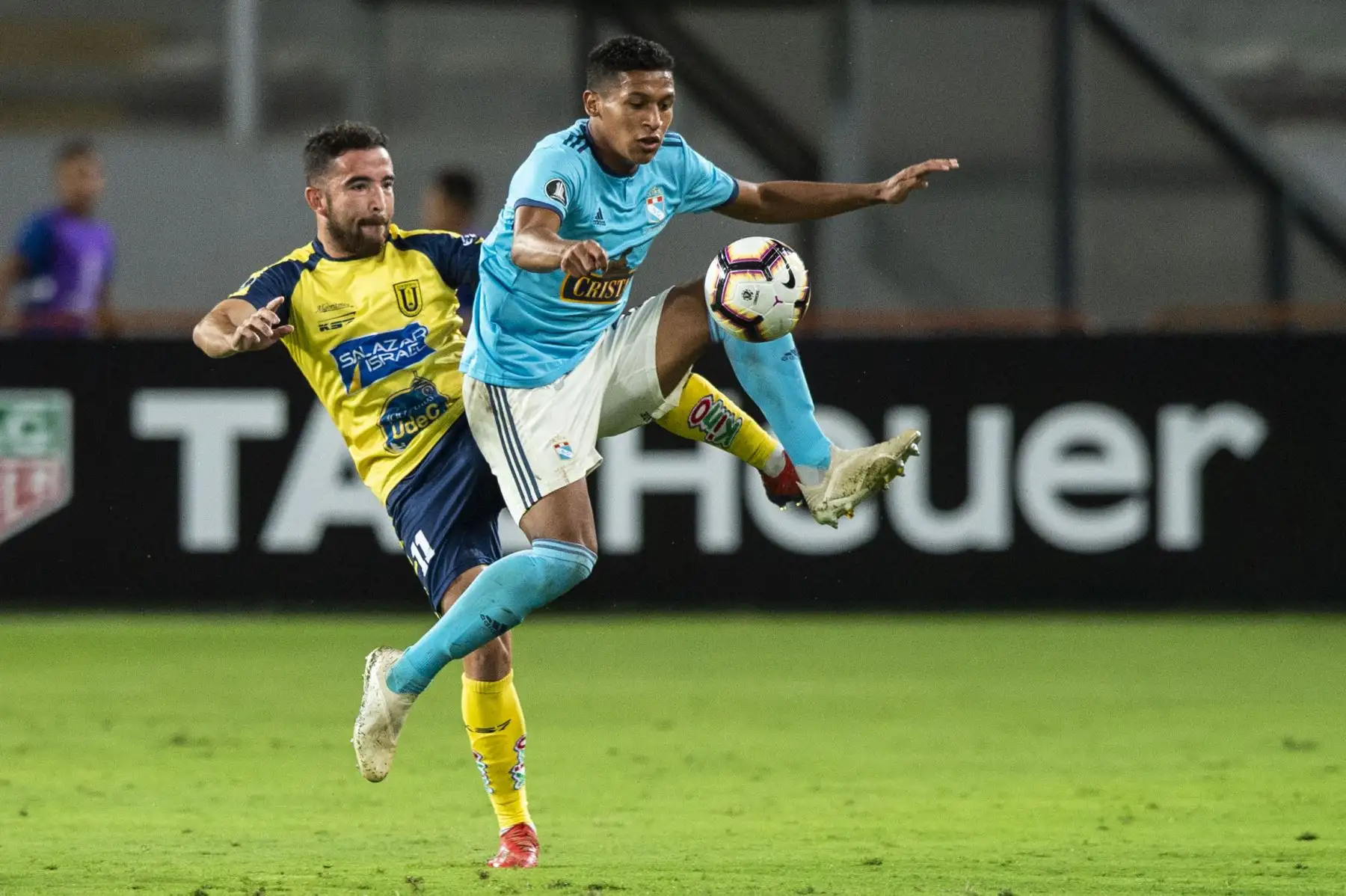 El jugador de la Universidad de Concepción de Chile, Fernando Cordero (L) compite por el balón con Fernando Pacheco (R) del Sporting Cristal  durante su partido de fútbol de la Copa Libertadores. AFP