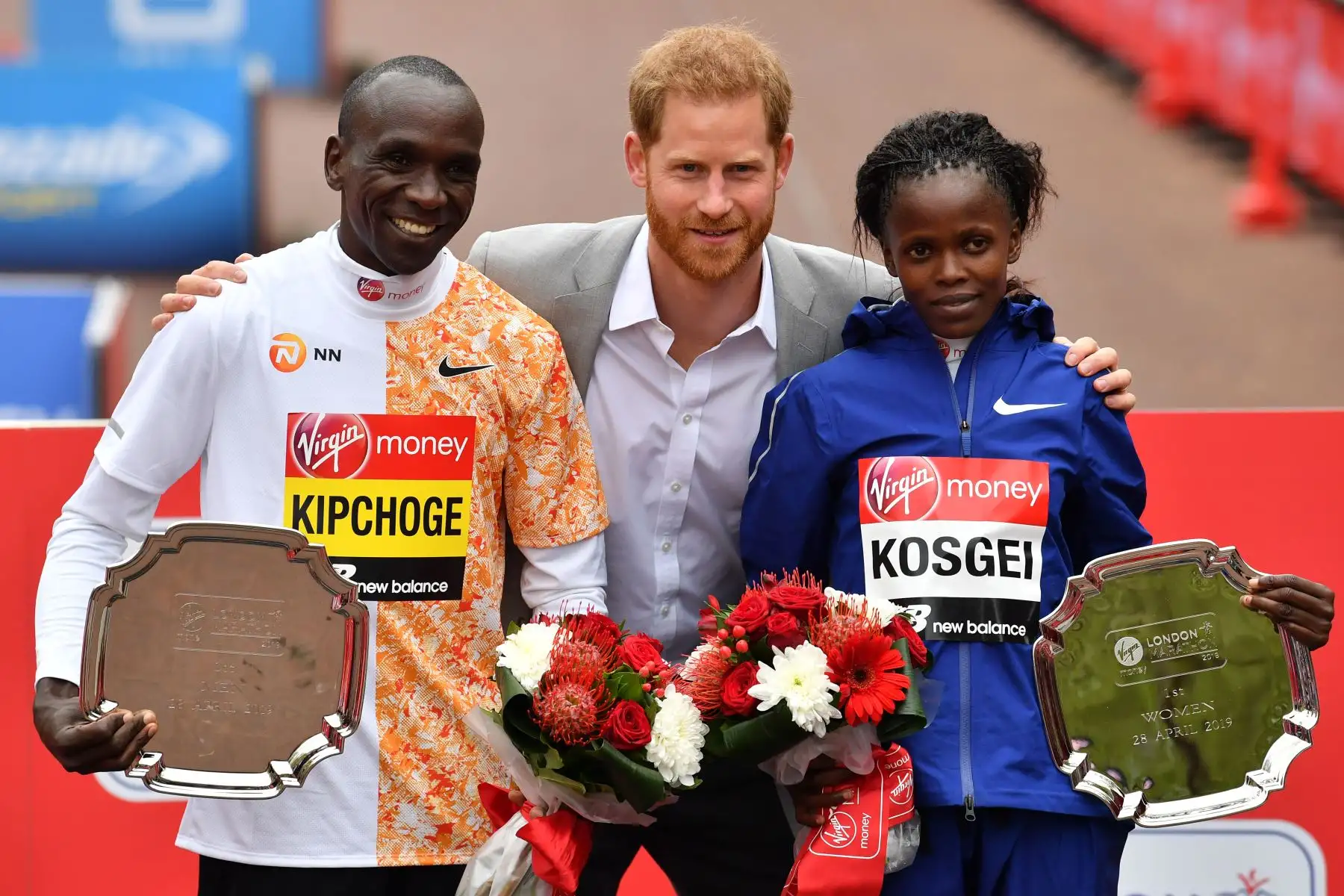 El Príncipe Harry de Gran Bretaña, Duque de Sussex, está flanqueado por el ganador de la carrera masculina Laiuda Kipchoge (L) de Kenia y la ganadora de la carrera femenina de Kenia, Brigid Kosgei (R) en la ceremonia de entrega de medallas en la Maratón de Londres 2019 .
Foto:AFP