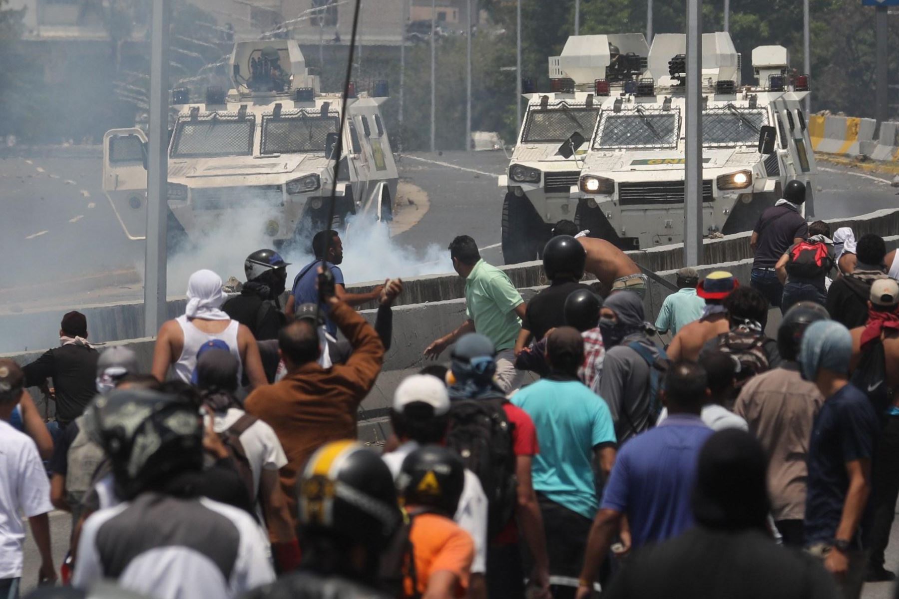 Manifestantes se enfrentan a los soldados leales al presidente venezolano Nicolás Maduro después de que las tropas se unieran al líder opositor Juan Guaidó en Caracas. Foto: EFE