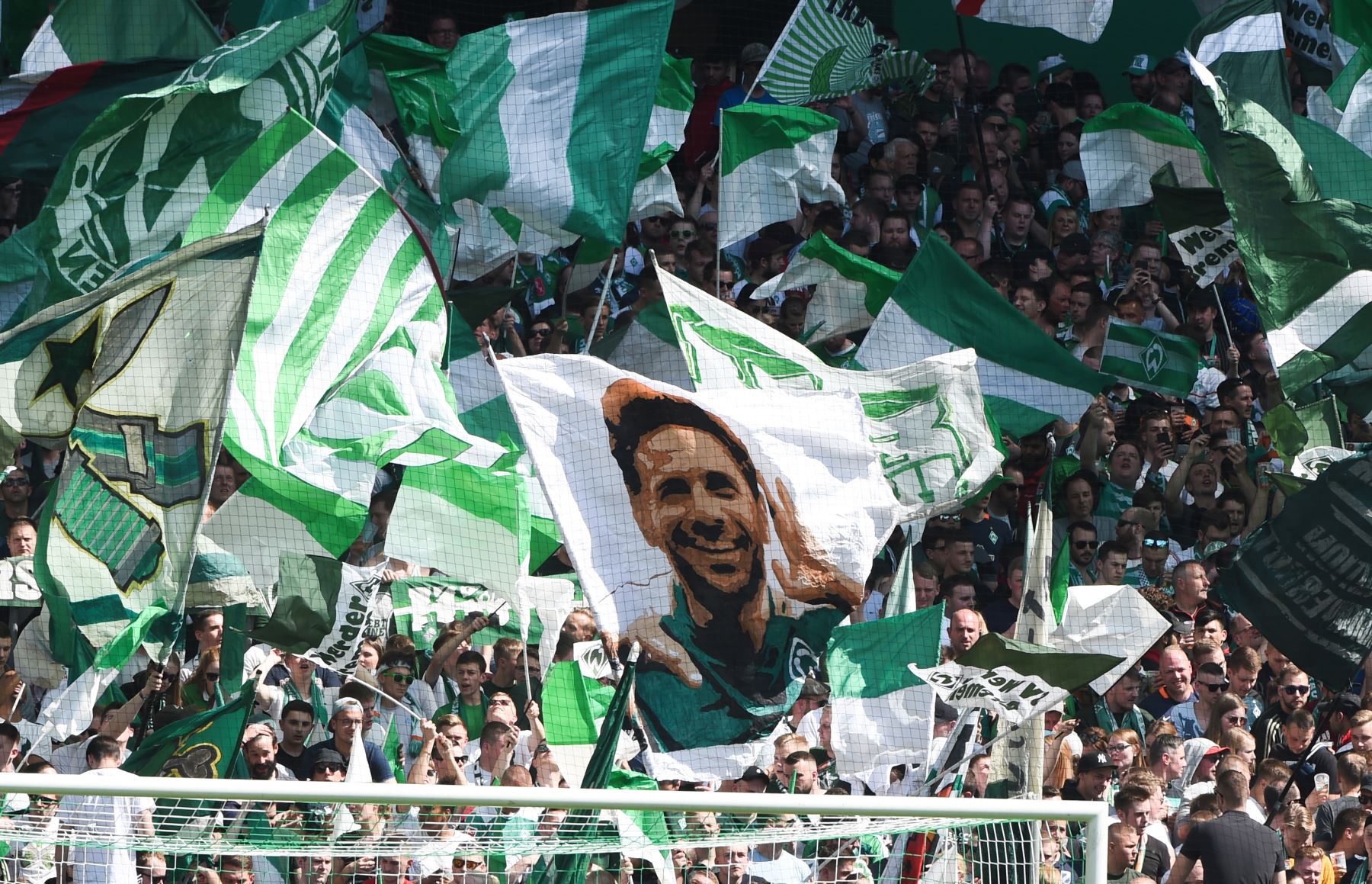 Los partidarios de Bremen ondean una bandera con una foto del delantero peruano de Bremen, Claudio Pizarro, quien renovó por una temporada más  con el  Werder Bremen de  Alemania.
Foto:AFP
