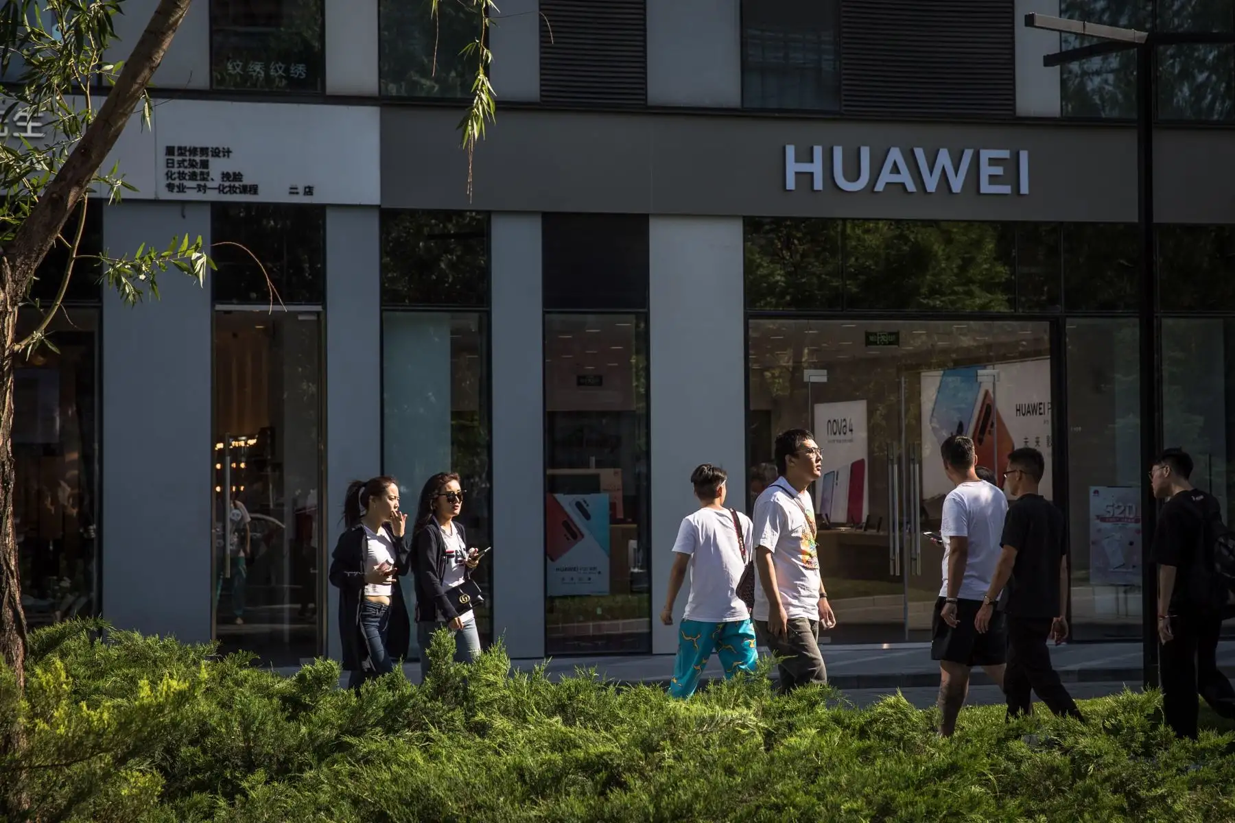 Varias personas caminan frente a una tienda de Huawei, este lunes en Pekín (China). El veto de Google y otras tecnológicas estadounidenses a Huawei podría frustrar la aspiración del fabricante chino de convertirse en breve en el mayor fabricante de móviles del mundo. Foto: EFE