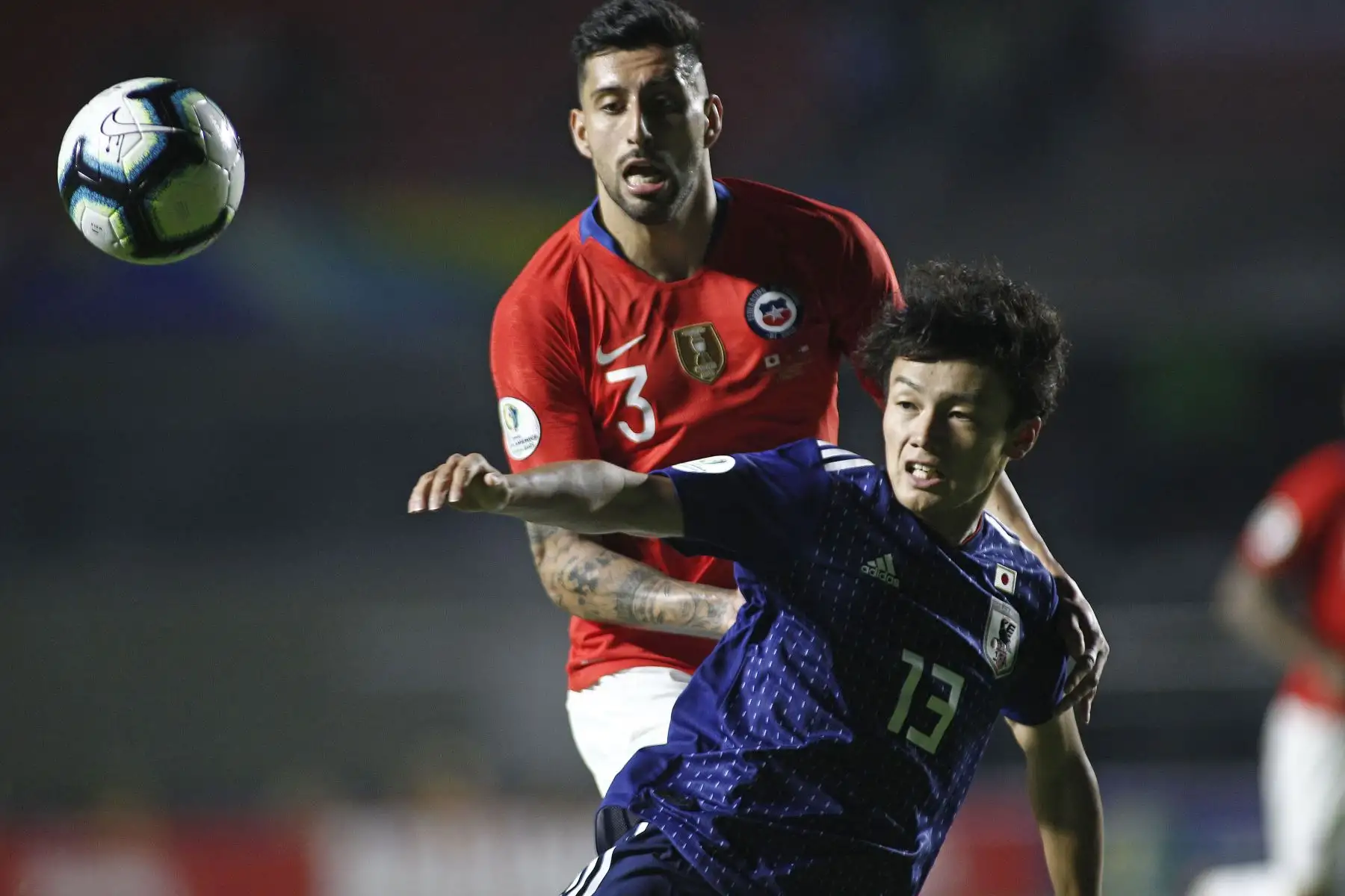 Guillermo Maripan (arriba) de Chile y Ayase Ueda de Japón luchan por el balón durante un partido del Torneo de fútbol Copa América 2019 del Grupo C entre Chile y Japón en el Estadio Cicero de Brasil.
Foto: AFP