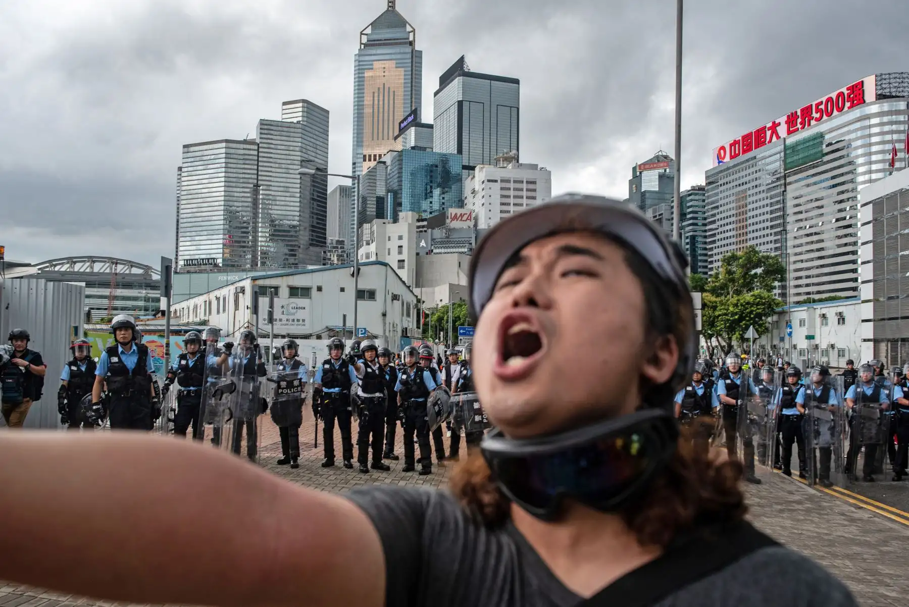 Un manifestante grita frente a la policía fuera de la sede del gobierno después de la ceremonia anual de izamiento de la bandera para conmemorar el 22 aniversario de la entrega de la ciudad de Gran Bretaña a China, en Hong Kong el 1 de julio de 2019. Foto: AFP