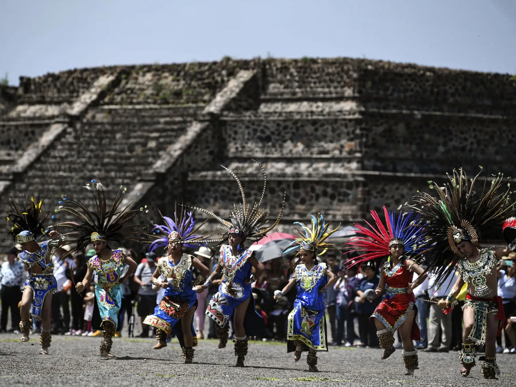 Los artistas recrean una danza azteca en el sitio arqueológico de Teotihuacan, en México, durante la ceremonia de encendido del fuego que se llevará a los Juegos Panamericanos de Lima. Foto: AFP.