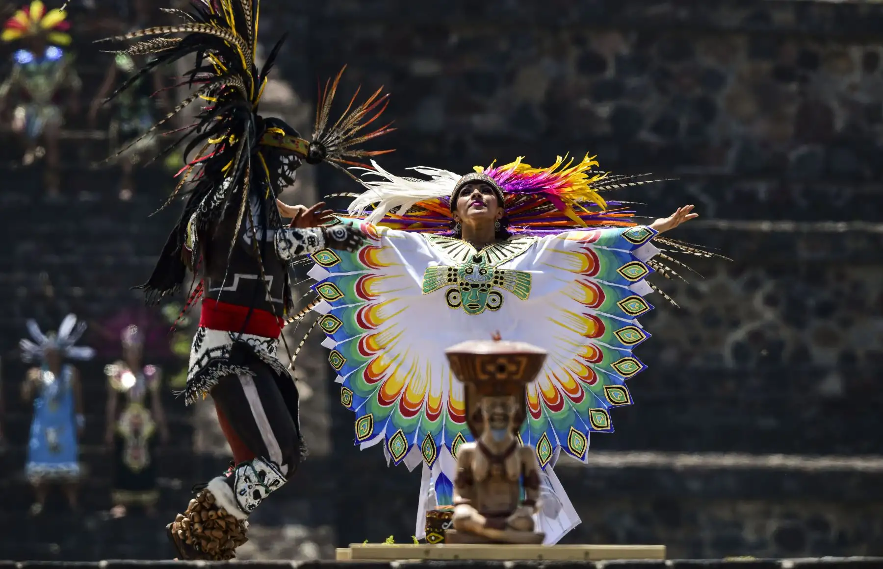 Los artistas recrean una danza azteca en el sitio arqueológico de Teotihuacán, en México, durante la ceremonia de encendido del fuego que se llevará a los Juegos Panamericanos de Lima. Foto: AFP.