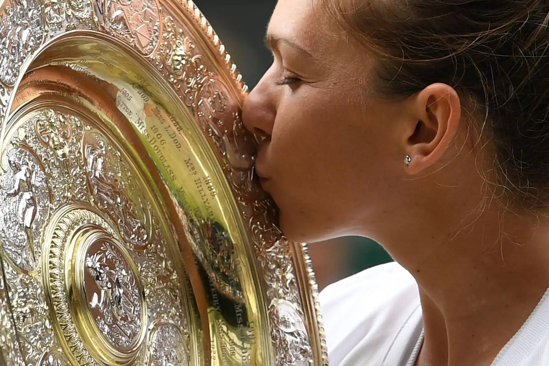 Simona Halep, de Rumania, besa el trofeo Venus Rosewater Dish luego de vencer a la jugadora estadounidense Serena Williams en la final de sus singles femeninas el día doce del Campeonato de Wimbledon 2019.
Foto: AFP