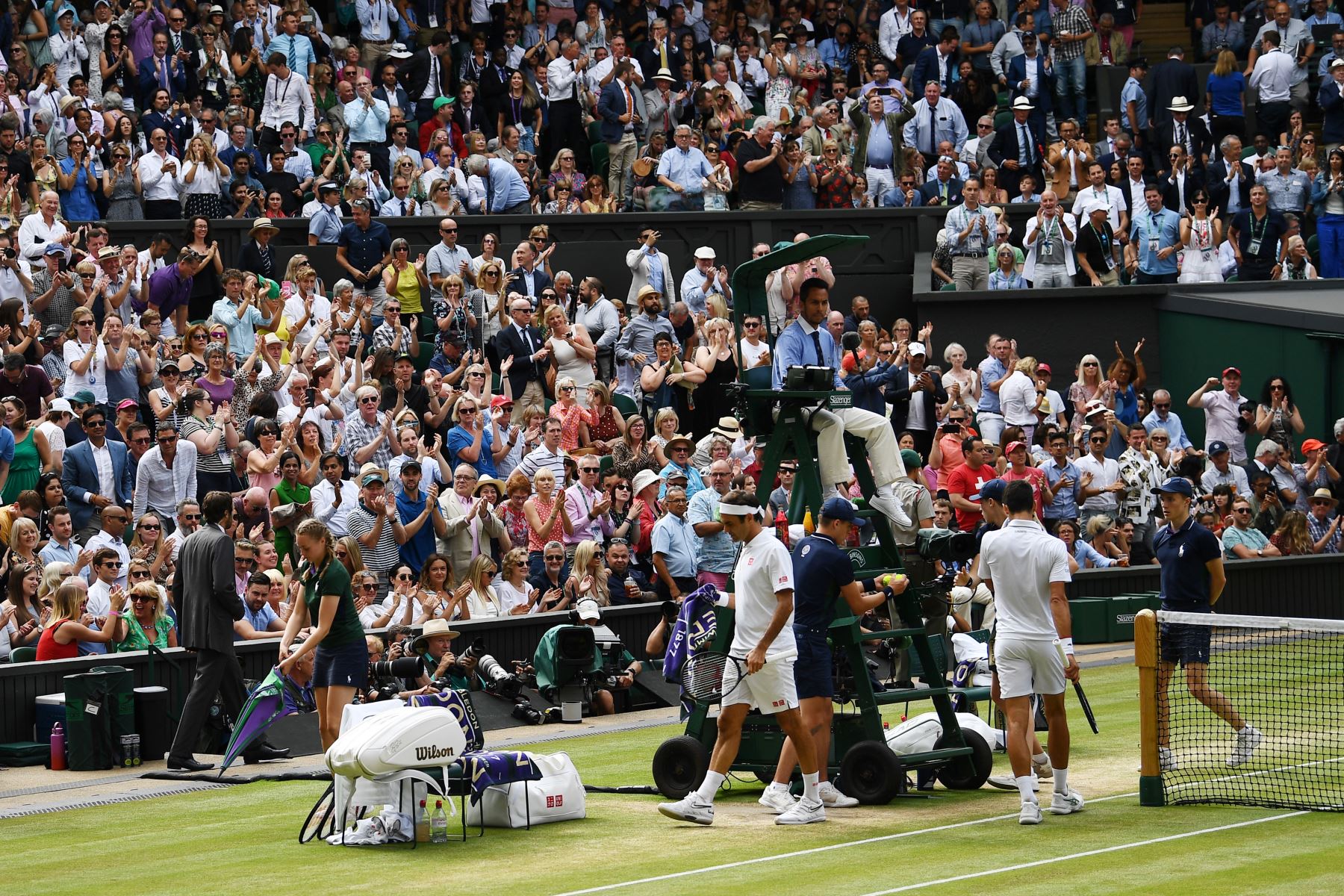 La multitud se pone de pie y aplaude al final de un juego mientras el suizo Roger Federer y el serbio Novak Djokovic toman sus asientos en la final de individuales masculinos el día trece del Campeonato de Wimbledon 2019.
Foto:AFP