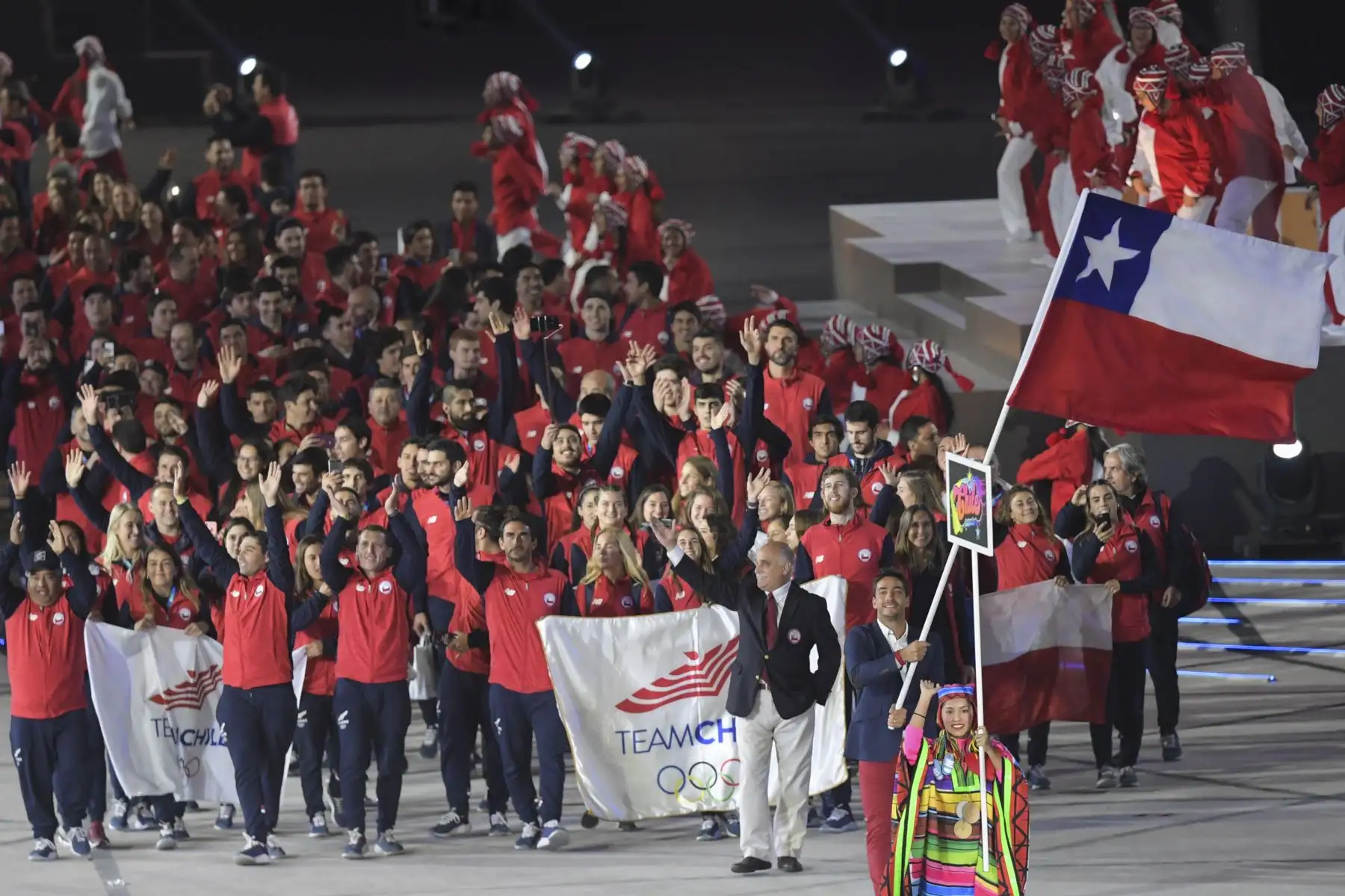 El portador de la bandera de Chile, el esquiador acuático Felipe Miranda, encabeza su delegación durante el Desfile de las Naciones de la ceremonia de apertura de Lima 2019.Foto:AFP