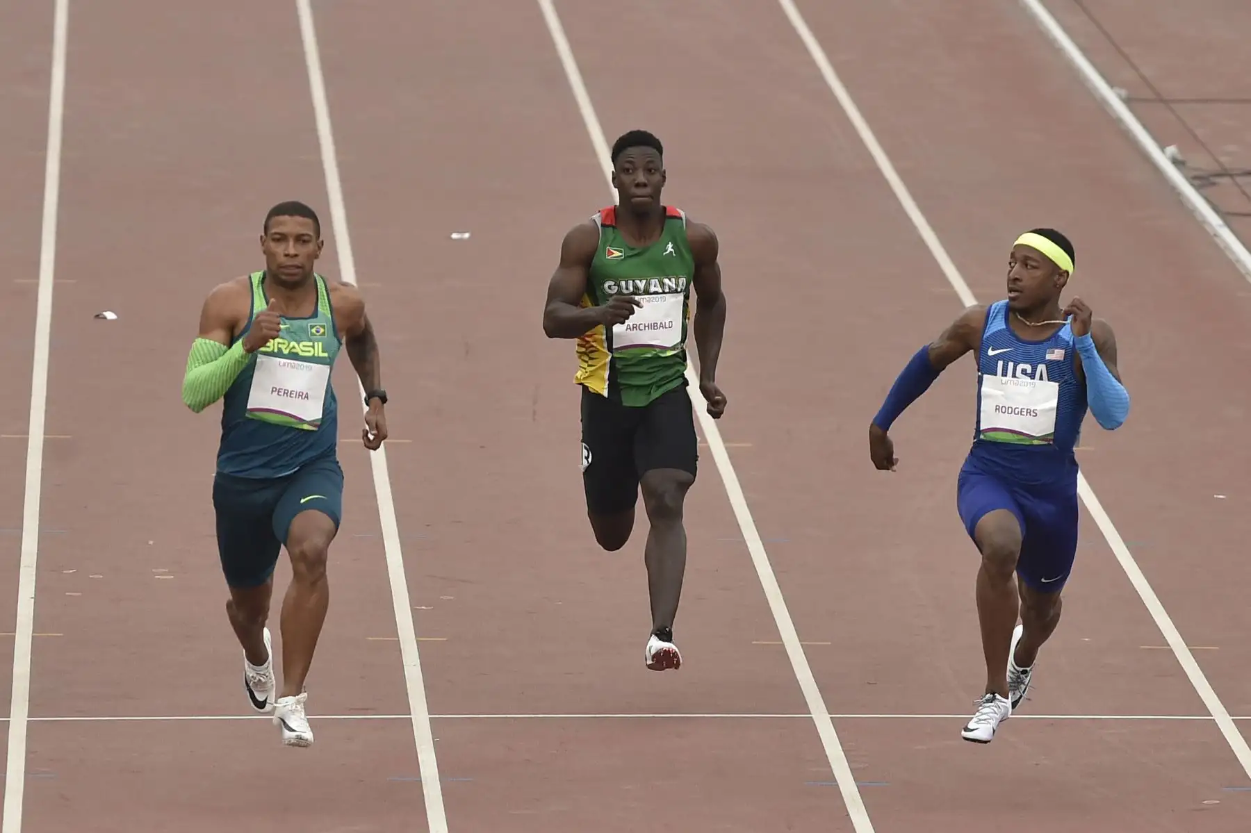 De izquierda a derecha) Rodrigo Pereira de Brasil, Emanuel Archibald de Guyana y Michael Rodgers de Estados Unidos compiten en la semifinal de atletismo masculino de 100 metros en los Juegos Panamericanos de Lima 2019.
Foto: AFP