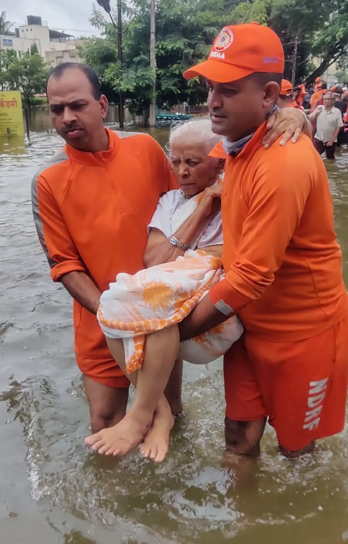 Fuerza Nacional de Respuesta a Desastres  transporta a una anciana varada en las inundaciones después de fuertes lluvias en las afueras de Sangli India. AFP