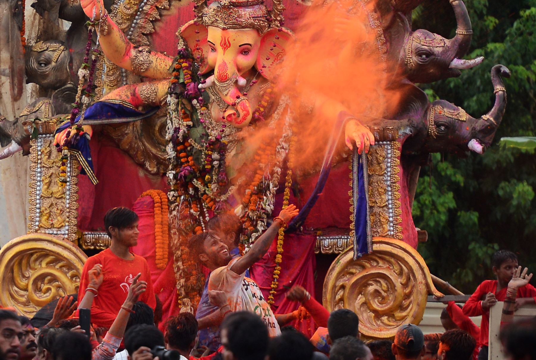 Devotos hindúes llevan ídolos de la deidad con cabeza de elefante en Mumbai. Foto: AFP