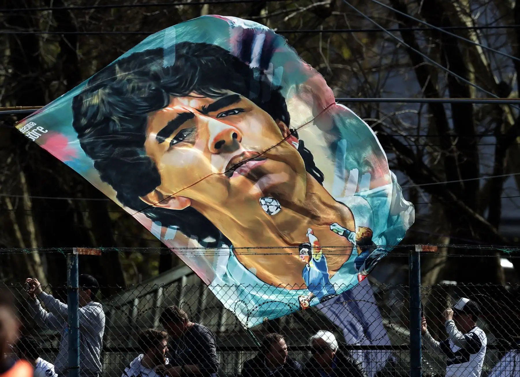 Hinchas de Gimnasia y Esgrima La Plata animan a su equipo con una banderola de Diego Armando Maradona.
Foto: AFP