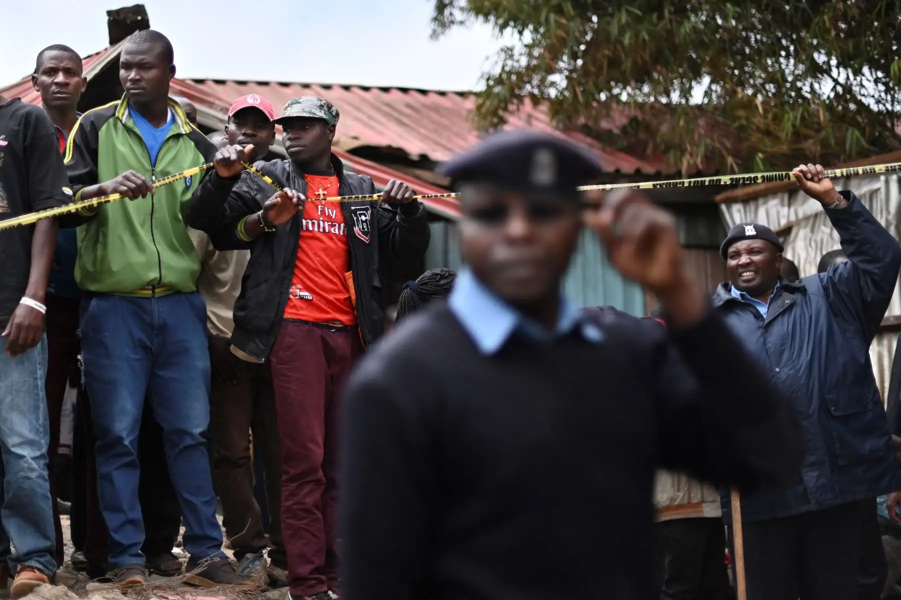 La gente se congrega detrás de un cordón policial donde un bloque de aulas se derrumbó en la escuela primaria Precious Talents en el distrito electoral de Dagoretti en Nairobi.
Foto: AFP