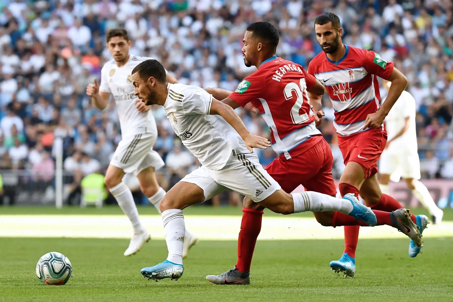 El delantero belga del Real Madrid Eden Hazard compite con el centrocampista venezolano de Granada Yangel Herrera durante el partido de fútbol de la Liga española. Foto: AFP